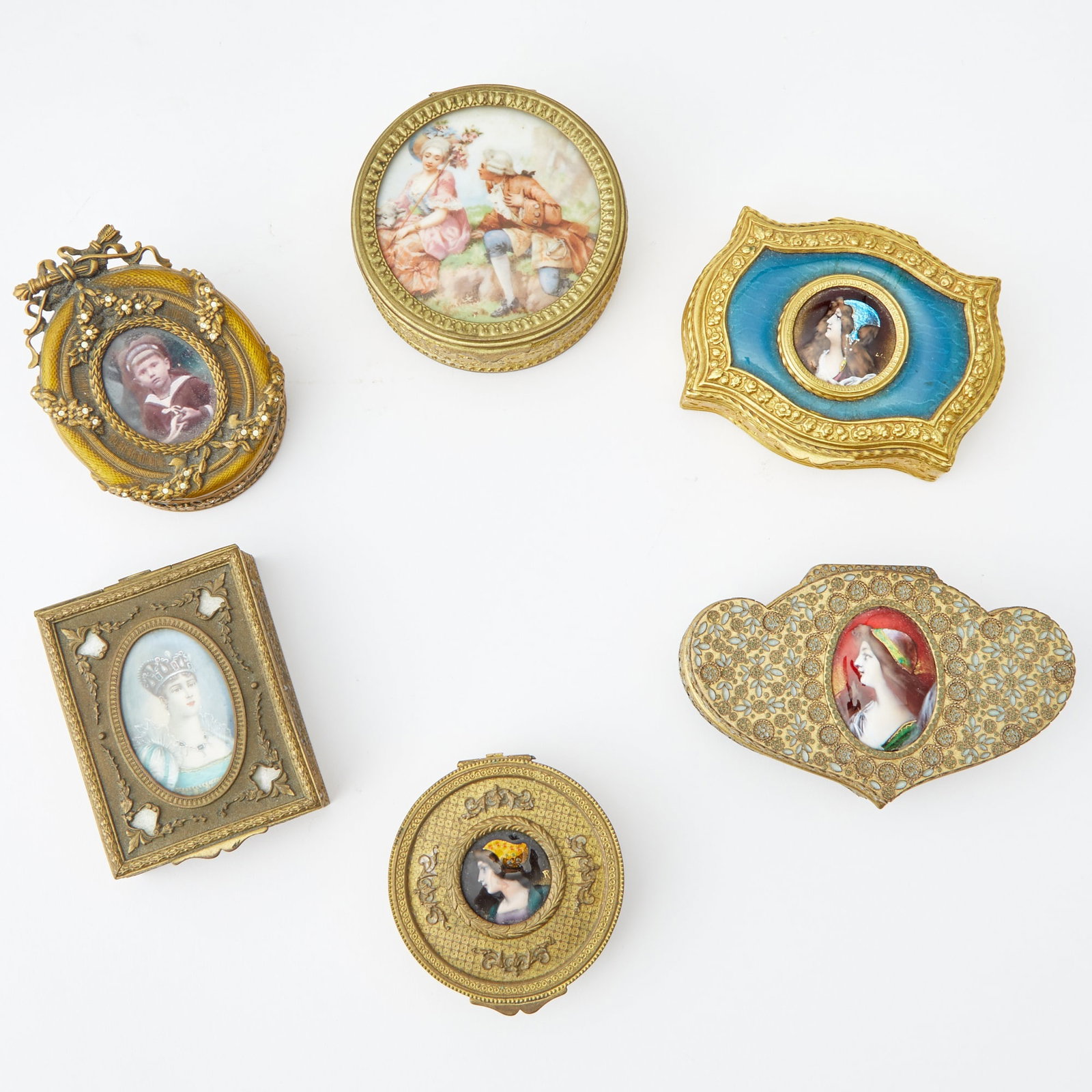 Group of Six Decorative Enamel and Porcelain Inset Boxes: Including three examples with Limoges style portraits of maidens. Height of largest 1 5/8 inches, width 4 3/4 inches.