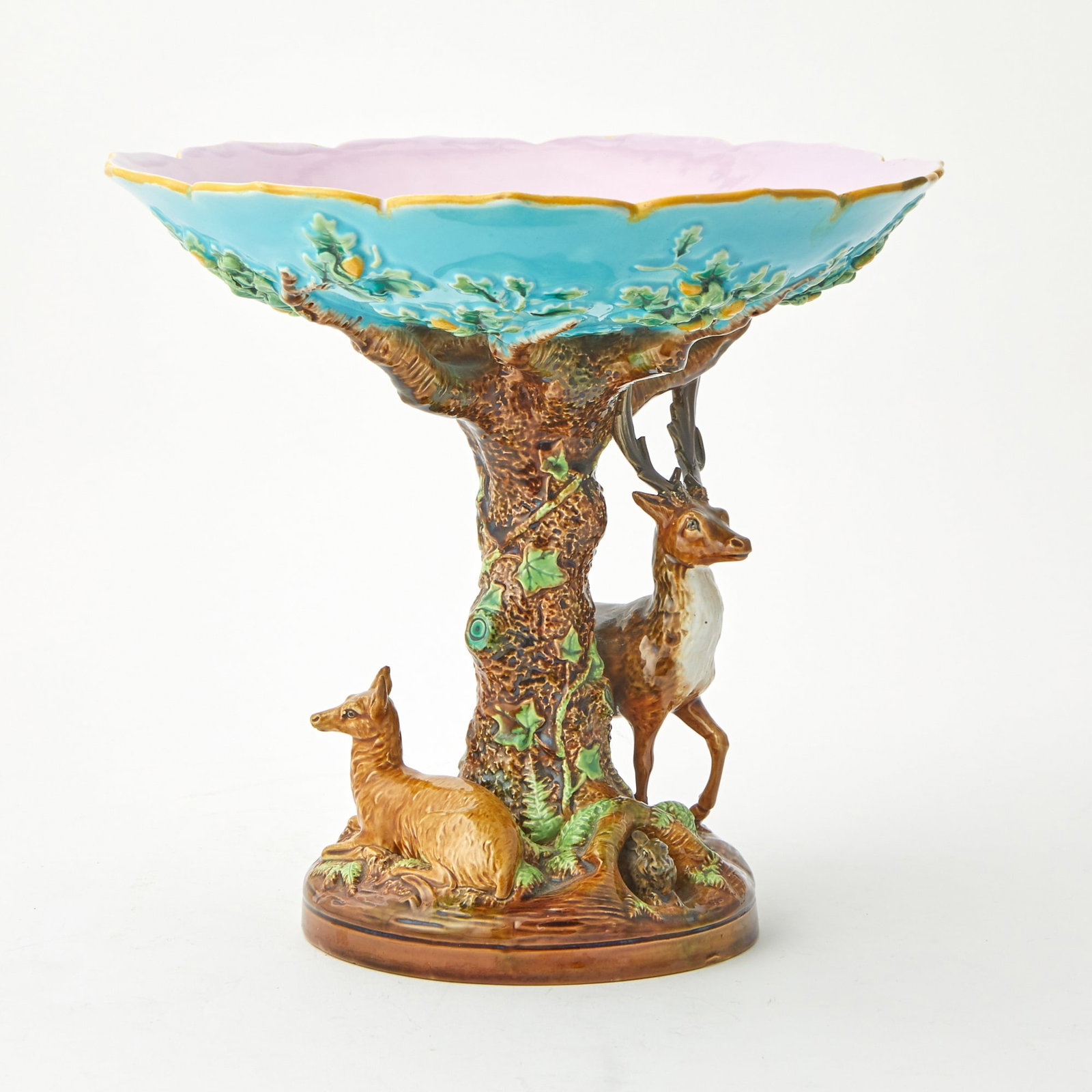 George Jones Majolica Turquoise Ground "Stag and Doe" Centerpiece Bowl Last quarter 20th century: Naturalistically modeled as a stag grazing on leaves beside a large tree, its branches spreading to hold a shallow bowl, a recumbent doe on the opposite side of the tree and a hare emerging from the b