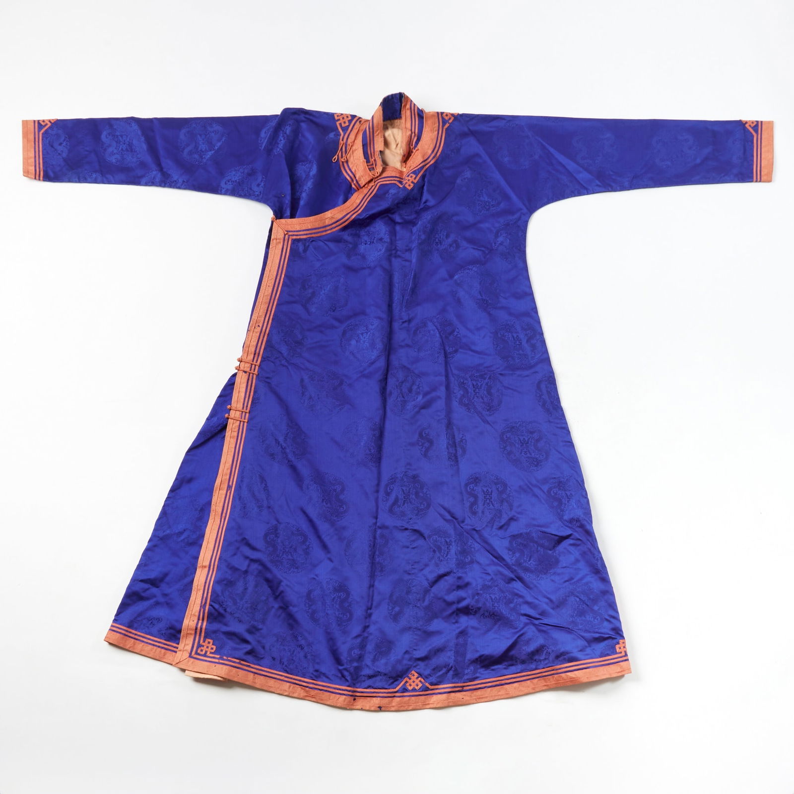 A Chinese Blue Ground Silk Lady's Robe Late Qing Dynasty: Woven with subtle patterns of dragon roundels.