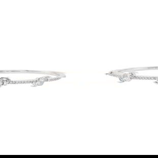 Mimi So White Gold and Diamond Bangle Bracelet: 318 kt., 3 oval diamonds ap. 1.65 cts., 29 round diamonds ap. .30 ct., signed Mimi So, no. 1441282, ap. 12 dwts. Inner cir. 6 1/2 inches. * Oval diamonds: I-J-SI. Width 1/4 inch.