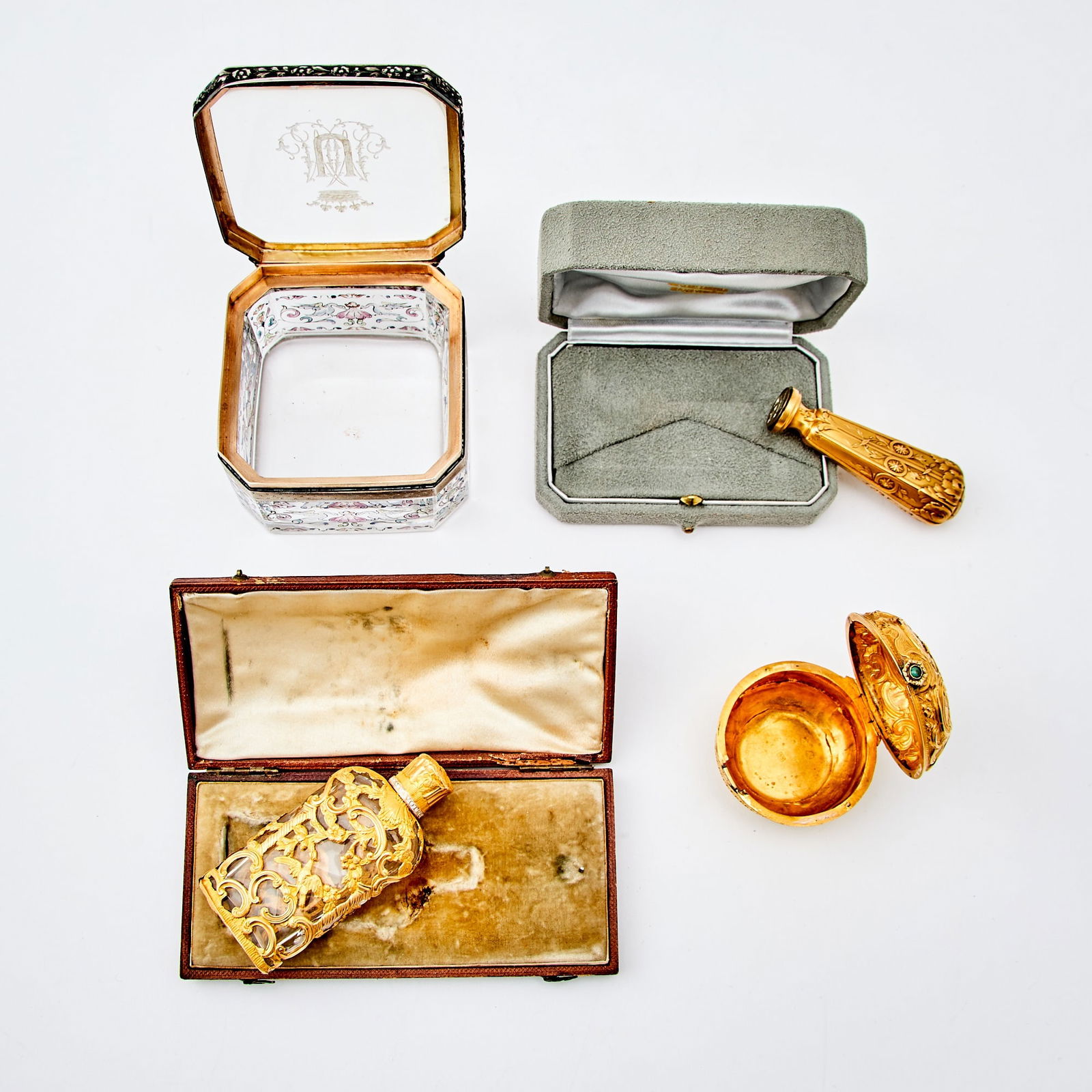 Group of Continental Gold Articles: Comprising a scent flask, length 2 3/4 inches (7 cm); hand seal, 2 1/2 inches (6.5 cm); pill box, diameter 1 3/4 inches (4.5 cm); Together with a Continental Glass Desk Box, 2 3/4 inches (7 cm)
