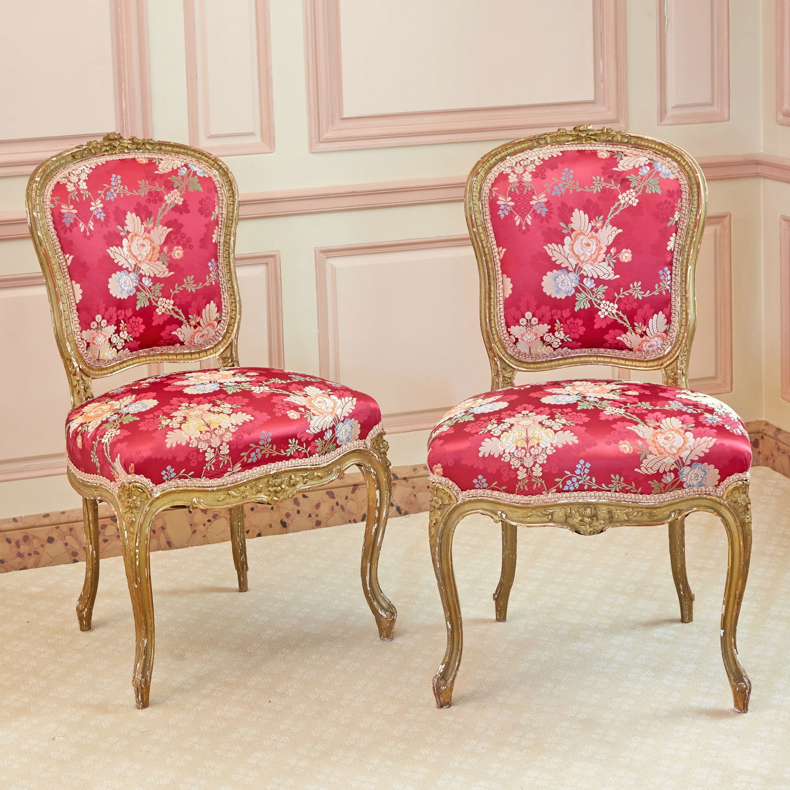Pair of Louis XV Style Upholstered Giltwood Chaises a la Reine: Estate / Collection: Property of a Fifth Avenue Philanthropist Each cartouche back with a floral crest, the molded frame and seat rail carved with flowers, raised on cabriole legs. Height of back 33 1