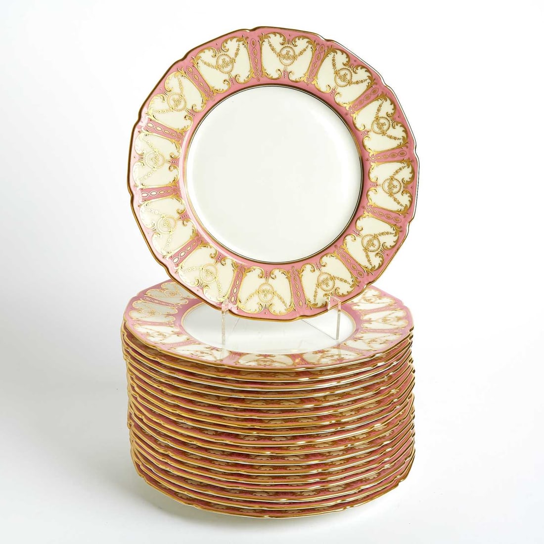 Eighteen Royal Doulton Pink-Ground Gilt-Decorated Service Plates: Estate / Collection: Property of a Fifth Avenue Philanthropist With green printed lion and crown marks, retailer’s marks for Cowell & Hubbard, Cleveland, impressed date cipher 16 and black p