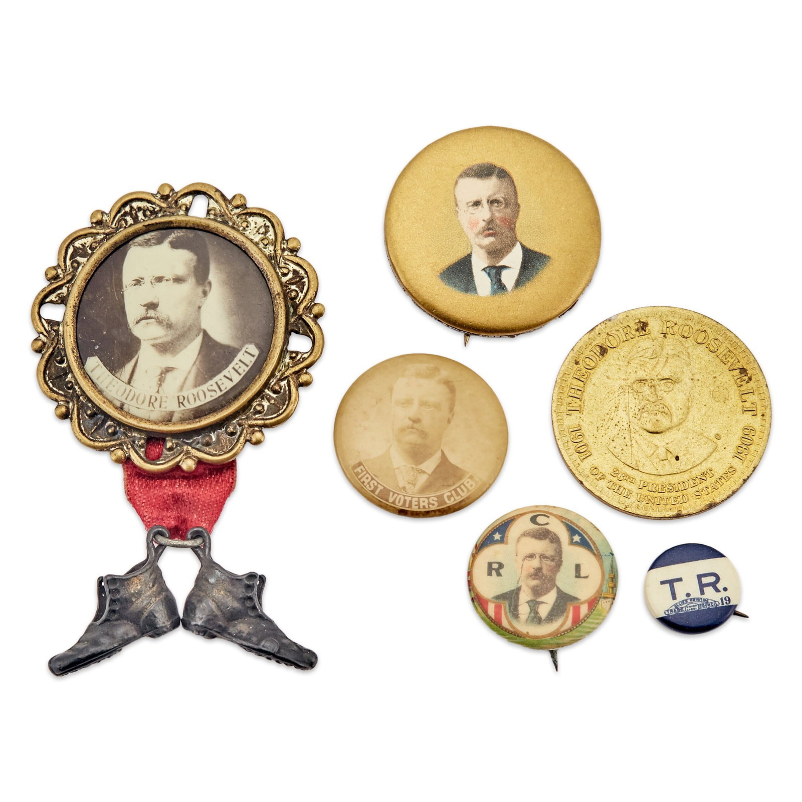 Political Collectibles: Theodore Rooseveelt Group: An offering of six items, ornate framed real photo with shoes attached on pin back approx. 42mm, four pin backs approximately 12 to 32 mm, and one brass medallion, Good to Excellent.
