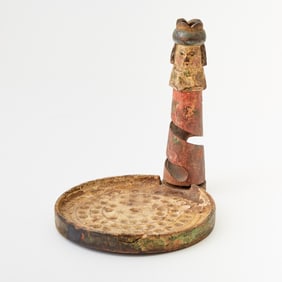 A whimsical carved and painted wood game of chance in the form of a chess king