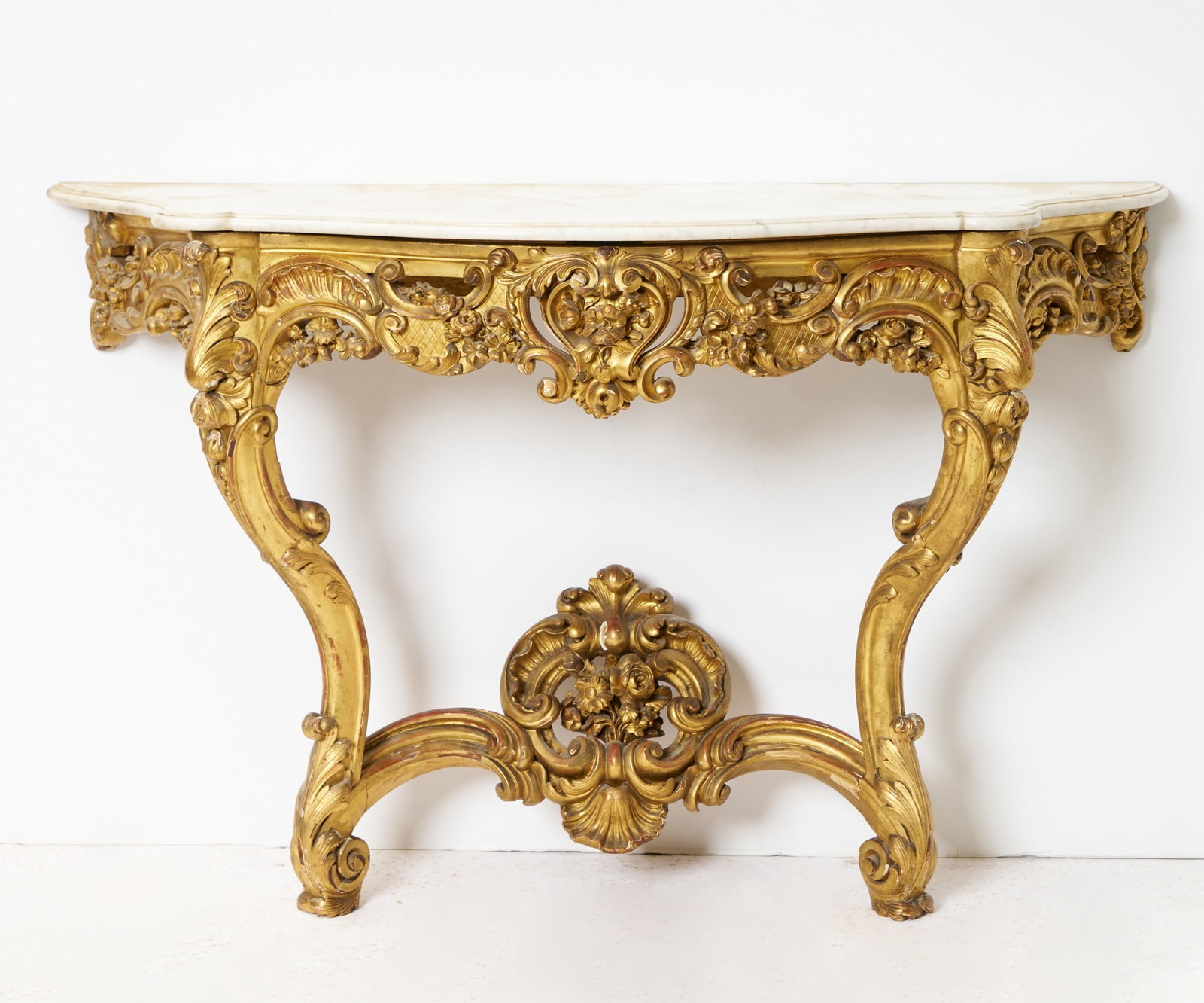 Continental Rococo Style Giltwood and Marble Console: Height 36 1/4 inches, width 57 inches, depth 21 1/2 inches. (1)