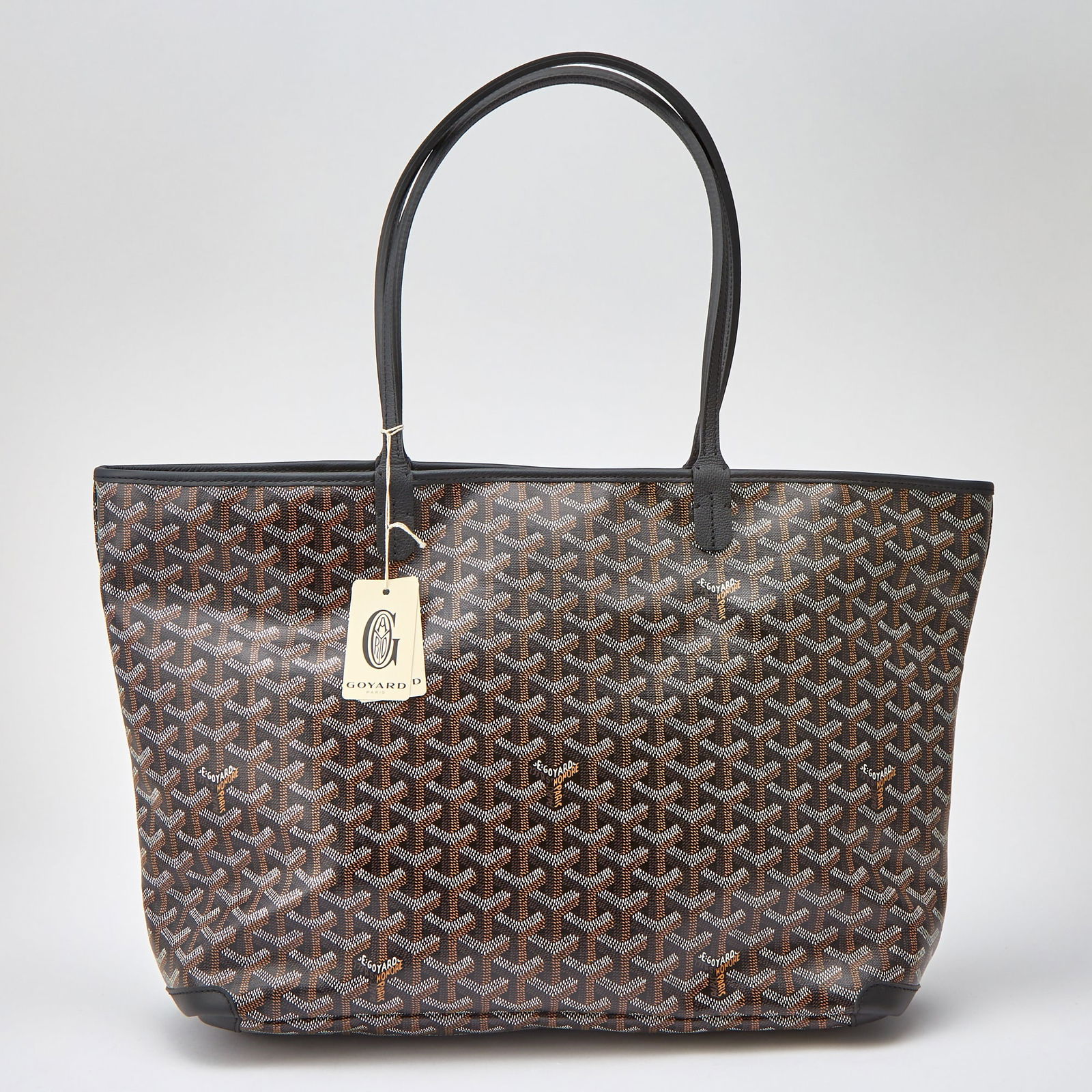 Goyard Goyardine Artois MM Bag: Printed canvas tote with black leather dual top handles and silver-tone zipper pull. Unlined white canvas interior with one side slip pocket, signed Goyard. 19 x 11 1/2 x 6 inches. With signed dust ba