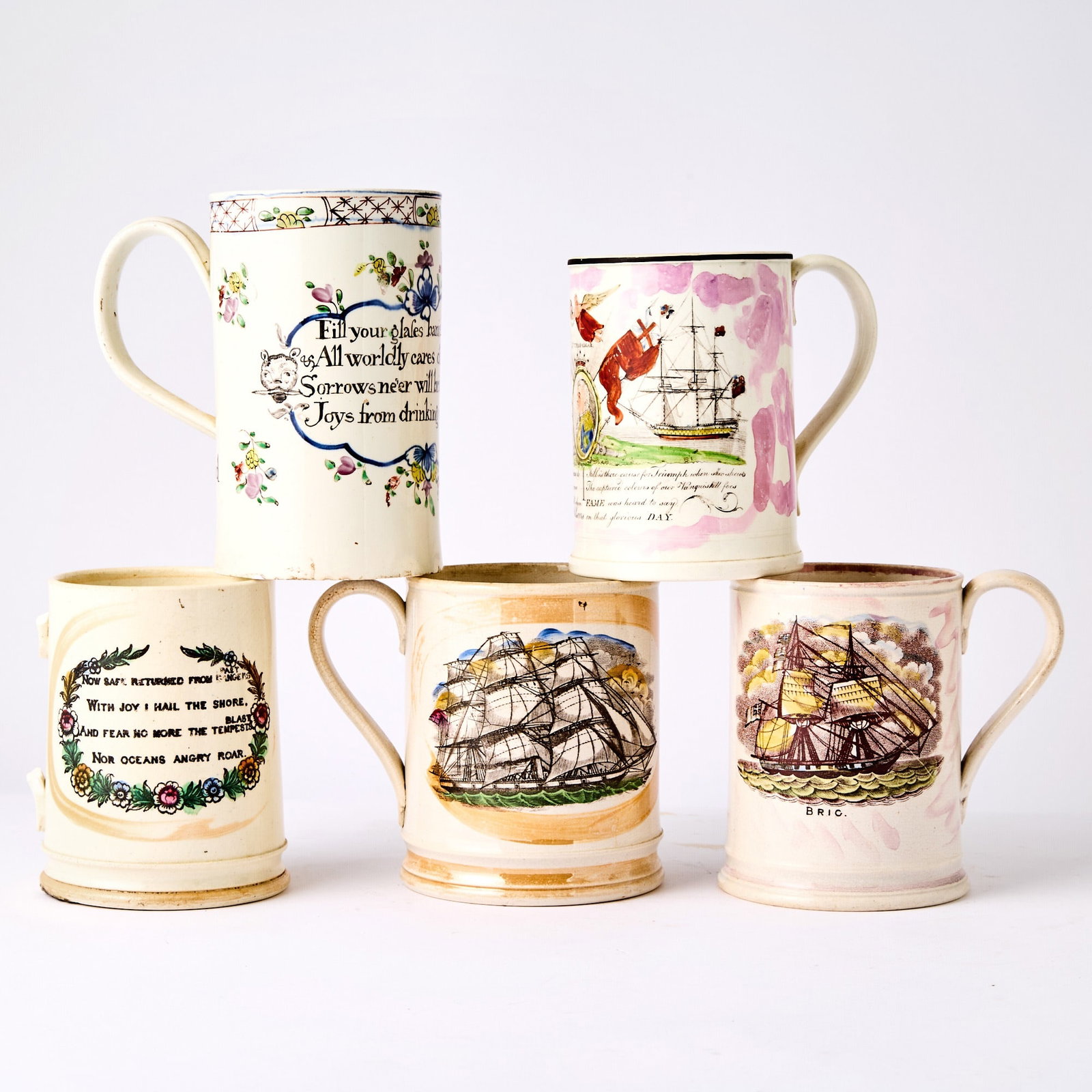 Group of Five Staffordshire Frog Mugs: 19th Century Estate / Collection: The Collection of Joanne B. Breyer Comprising a mug transfer-printed with the frigate Bric and a verse on the reverse; example with a schooner within orange lustre de