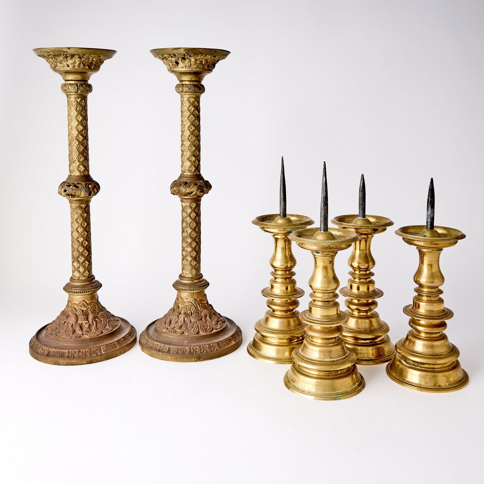 Group of Six Continental Brass Candlesticks: Estate / Collection: The Collection of Joanne B. Breyer 19th/20th Century Comprising a set of four Dutch Baroque style pricket sticks, height 11 inches; and a pair of Gothic Revival style candlesticks