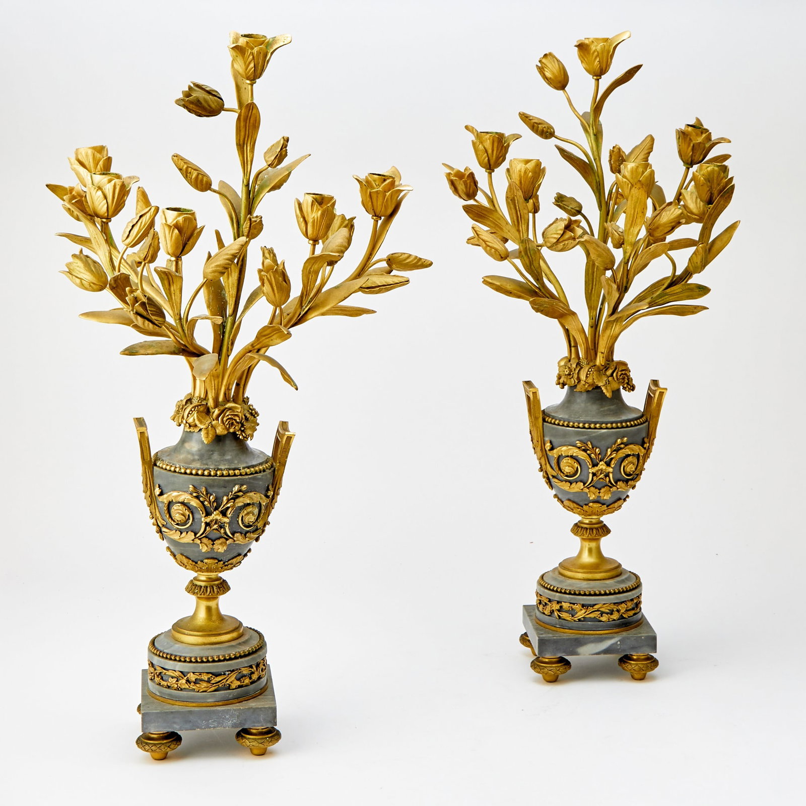 Pair of Gilt Metal-Mounted Urns of Flowers: Estate / Collection: The Collection of Joanne B. Breyer Each designed as tulips above a scroll-mounted urn and pedestal base with four gilt bronze feet. Height 27 inches. some elements sl