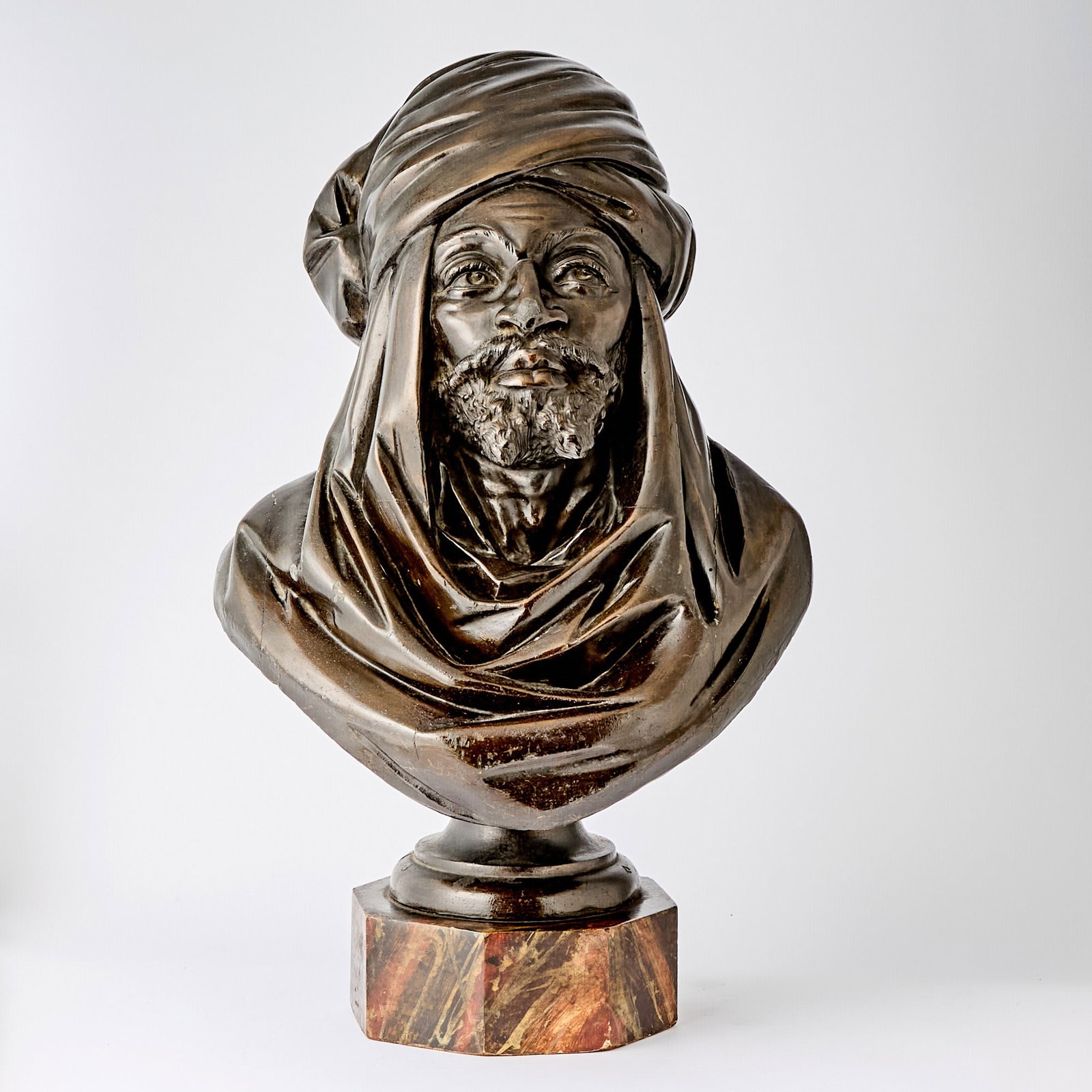 Continental Carved Wood Bust of a Moroccan Man: Estate / Collection: The Collection of Joanne B. Breyer 20th Century The bearded man wearing a turban. Height 25 inches, width 16 inches.