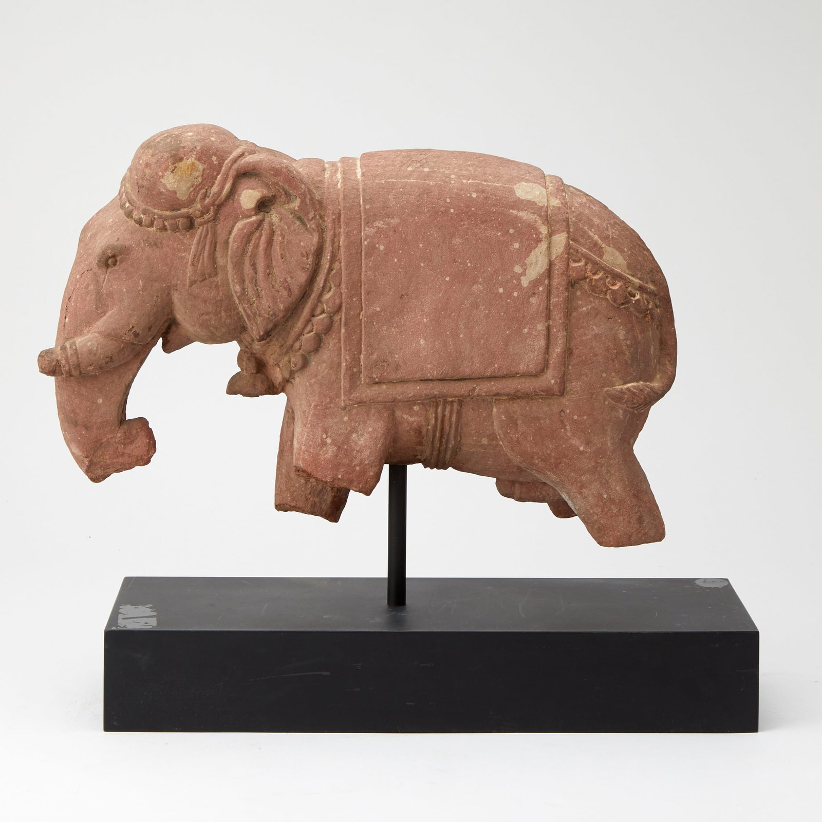 Indian Carved Mottled Red Sandstone Fragment of an Elephant: Estate / Collection: The Collection of Joanne B. Breyer The standing figure depicted with trappings. Height of figure 11 1/4 inches, length 17 inches. Provenance: Sothebyâ€™s, Indian 