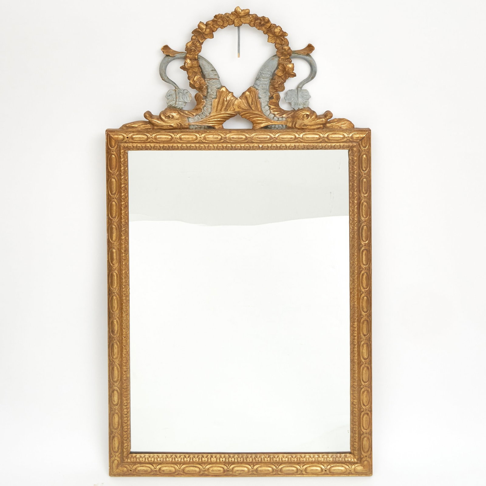 Venetian Neoclassical Style Giltwood and Gesso Mirror: 19th Century Estate / Collection: The Collection of Joanne B. Breyer The rectangular mirror with entwined dophin cresting, the dolphins painted in blue. Height 55 inches, width 29 inches.