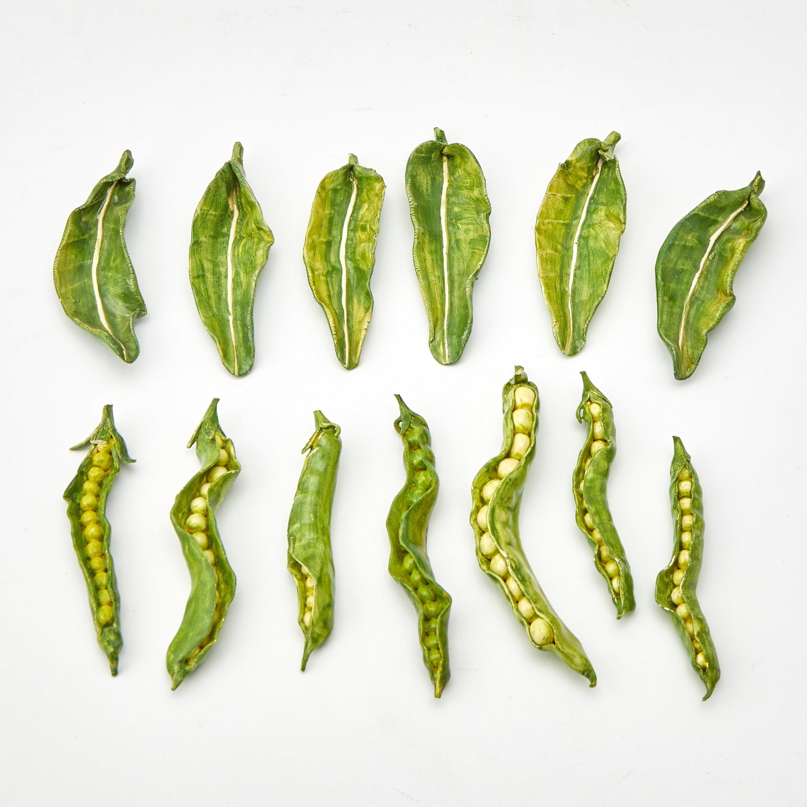 Group of French Ceramic Leaves and Peapods: 20th Century Estate / Collection: The Collection of Joanne B. Breyer Comprising seven peapods and six leaves, four leaves marked CL France. Length of largest 5 inches.
