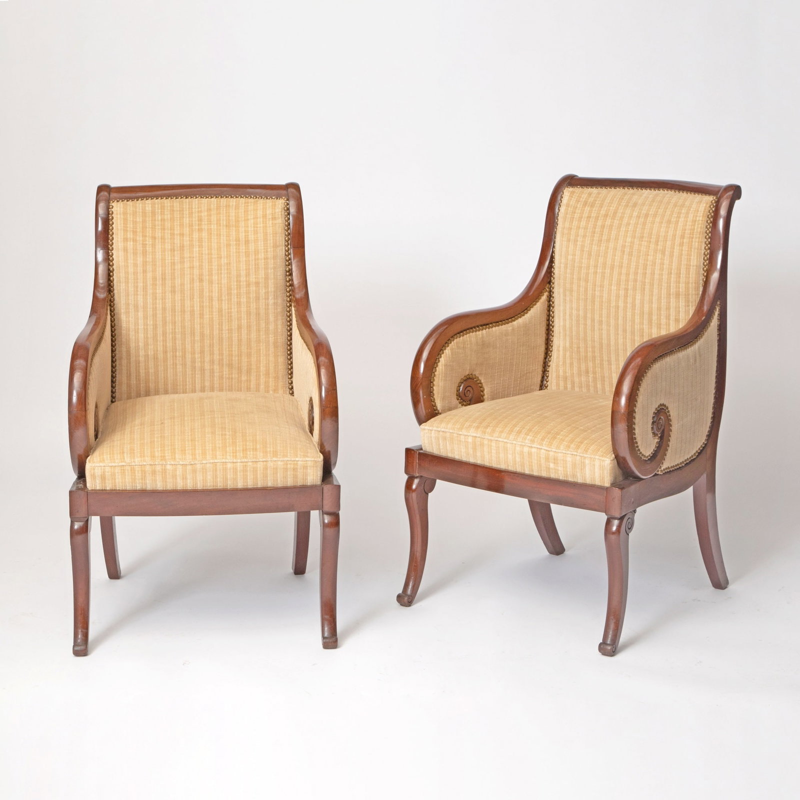 Pair of Louis Philippe Upholstered Mahogany Bergères: Height 36 1/4 inches, width 22 1/4 inches, depth of seat 18 inches, height of seat 17 inches.