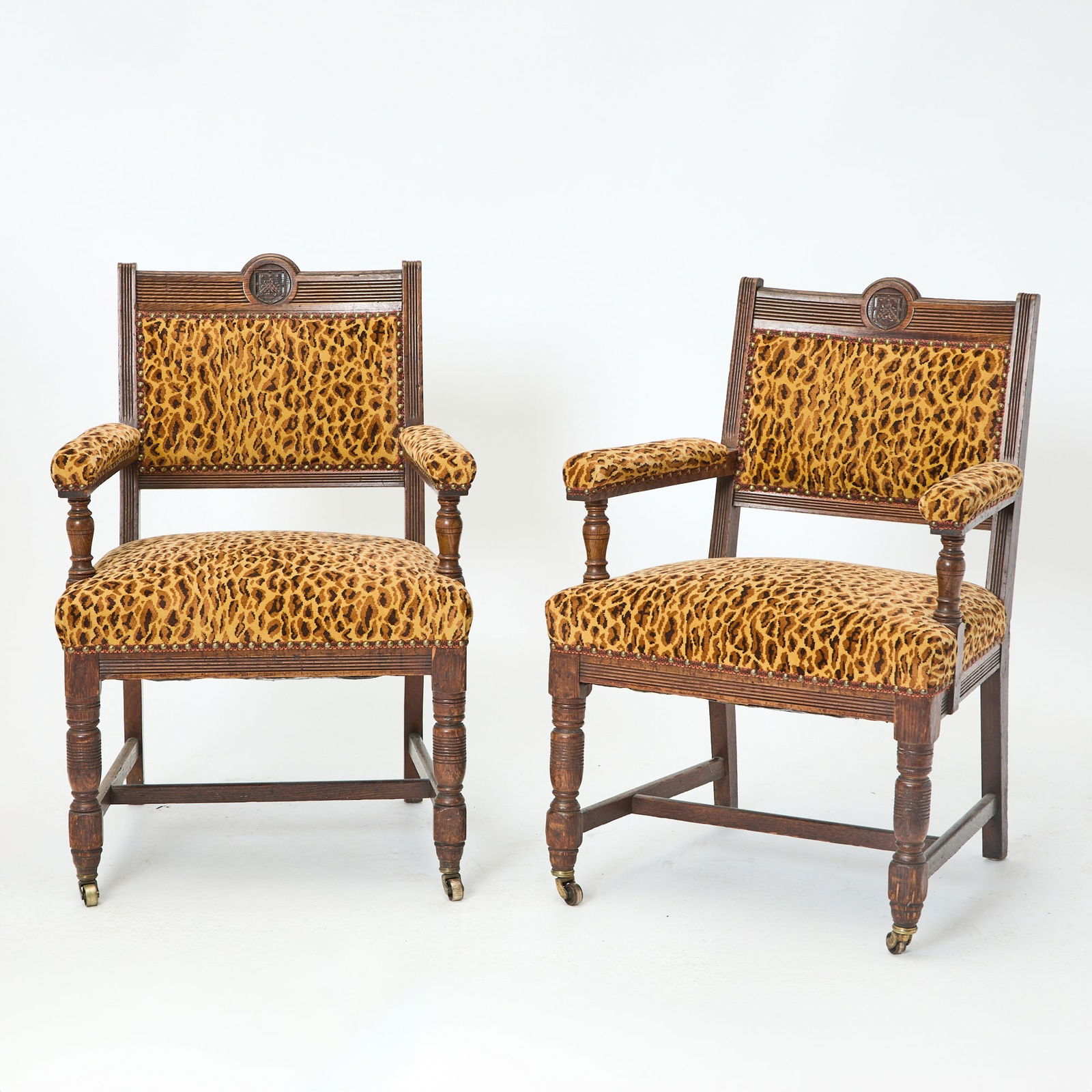 Pair of Leopard Upholstered Carved Oak Armchairs: Height 37 1/4 inches, width 26 1/4 inches, depth of seat 22 inches, height of seat 20 inches.