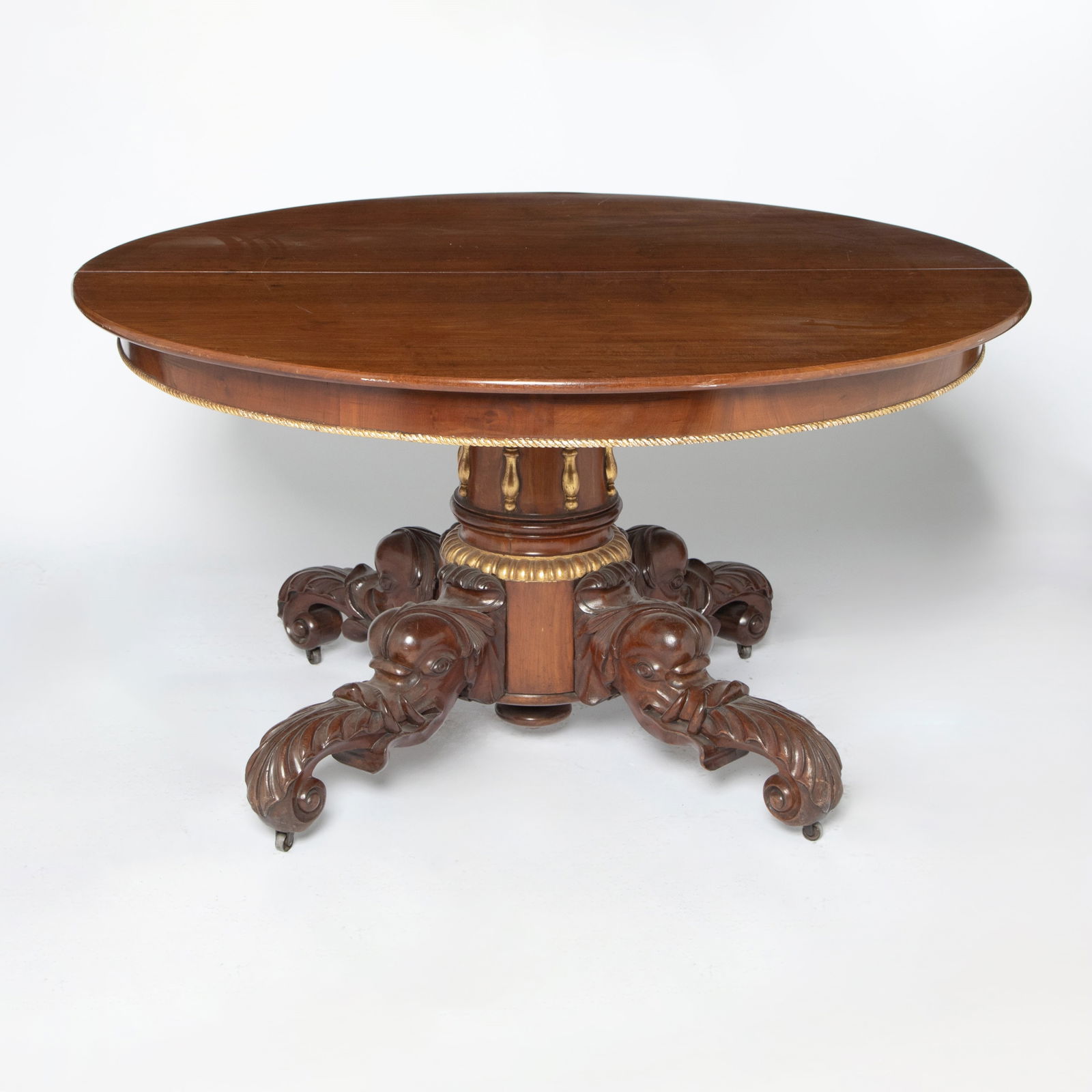 Regency Style Parcel-Gilt Mahogany Dining Table: Height 30 1/2 inches, diameter 53 inches.