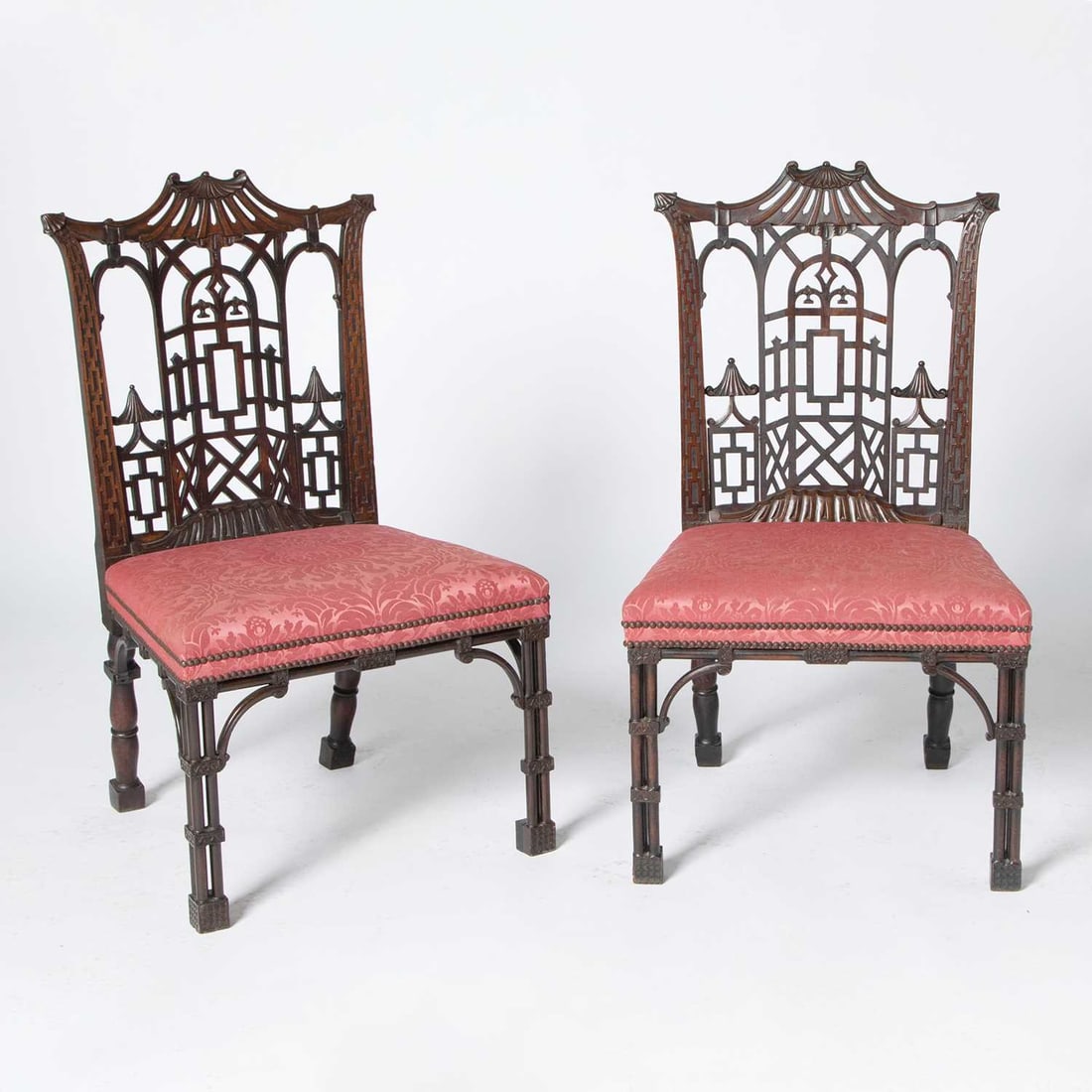 Pair of George III Style Mahogany Side Chairs: 19th CenturyIn the manner of Thomas Chippendale. Each with a stylized pagoda cresting above a trellis-shaped back splat in the form of an arched perspective ornamented with further pagodas, and suppor