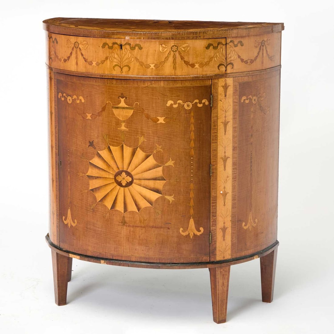 Irish George III Harewood, Sycamore, Ebonized and Marquetry Demilune Cabinet: In the manner of William Moore of Dublin, late 18th century Height 37 inches, width 32 inches, depth 16 3/4 inches.