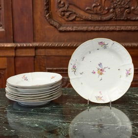 Seven Meissen Porcelain Molded Flower Decorated Plates and a Small Charger