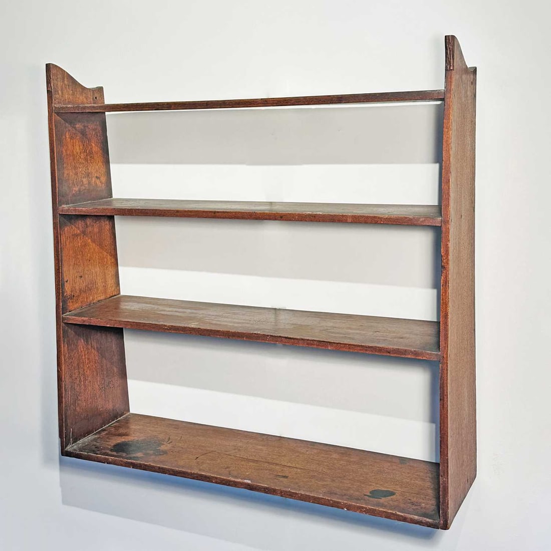 Walnut Four-tier Wall Shelf: New England, 19th century With canted sides. Height 29 1/2 inches, width 30 inches, depth 8 inches.