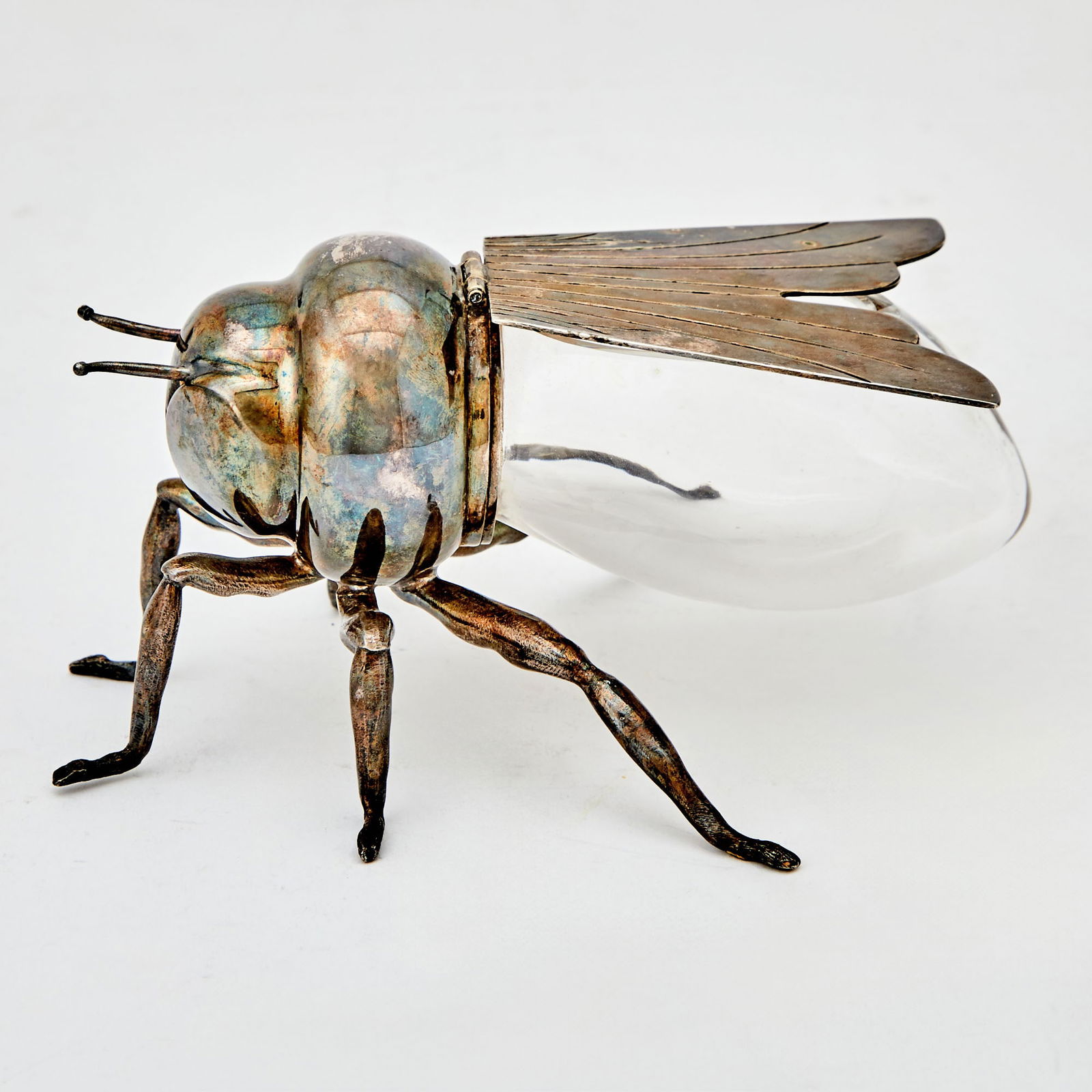 Mappin & Webb Silverplate and Blown Glass Bee-Form Honey Pot: London, circa 1930 The hinged wing over a colorless glass body, with silverplate wings, head, and legs. Height 3 1/4 inches, length 6 3/4 inches, width 3 1/2 inches. Stamped