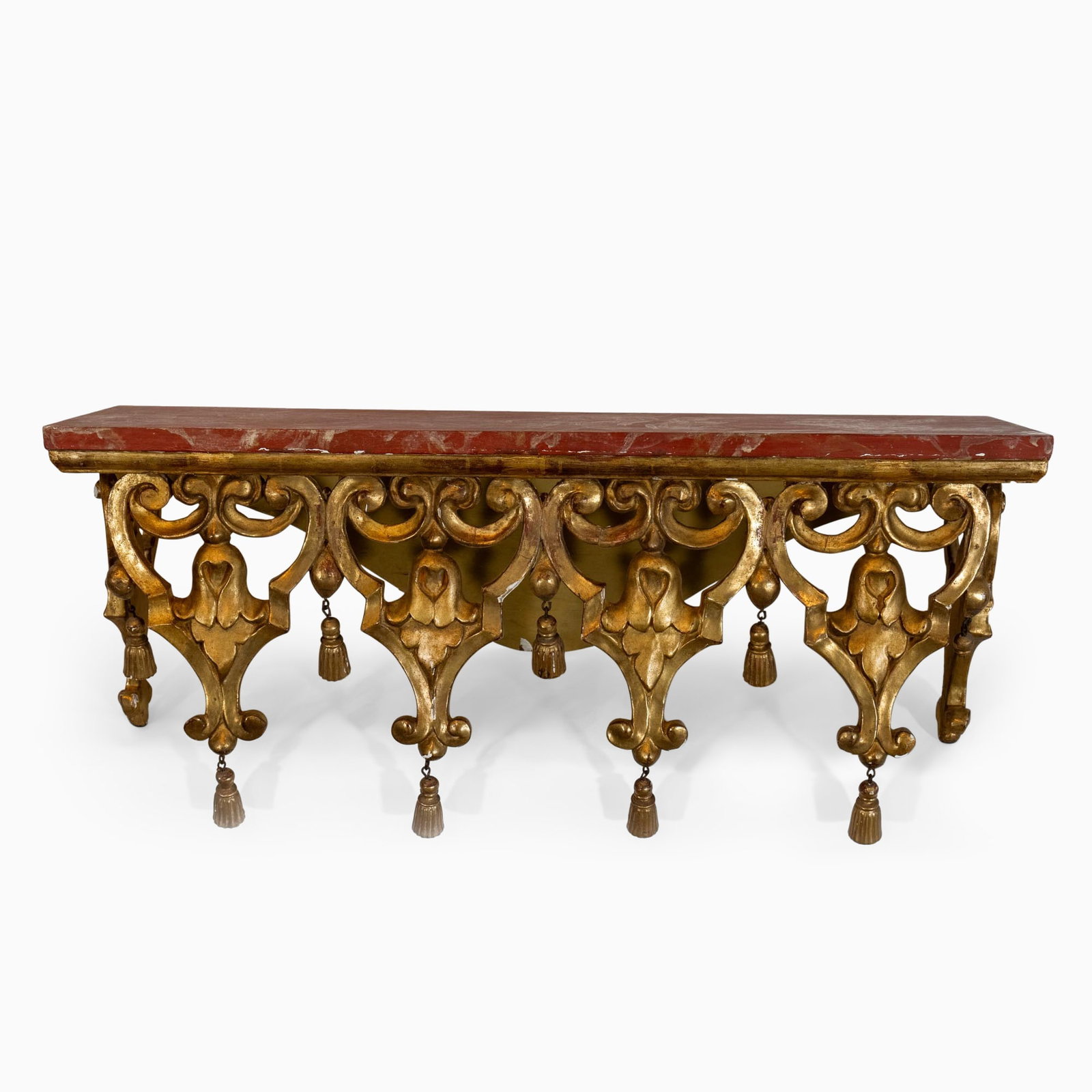 Rococo Style Giltwood Console d'Applique: 20th Century The red faux marble rectangular top over a pieced scrolled apron hung with tassels. Height 14 inches, length 32 1/2 inches, depth 10 1/2 inches. wear to edges of the to
