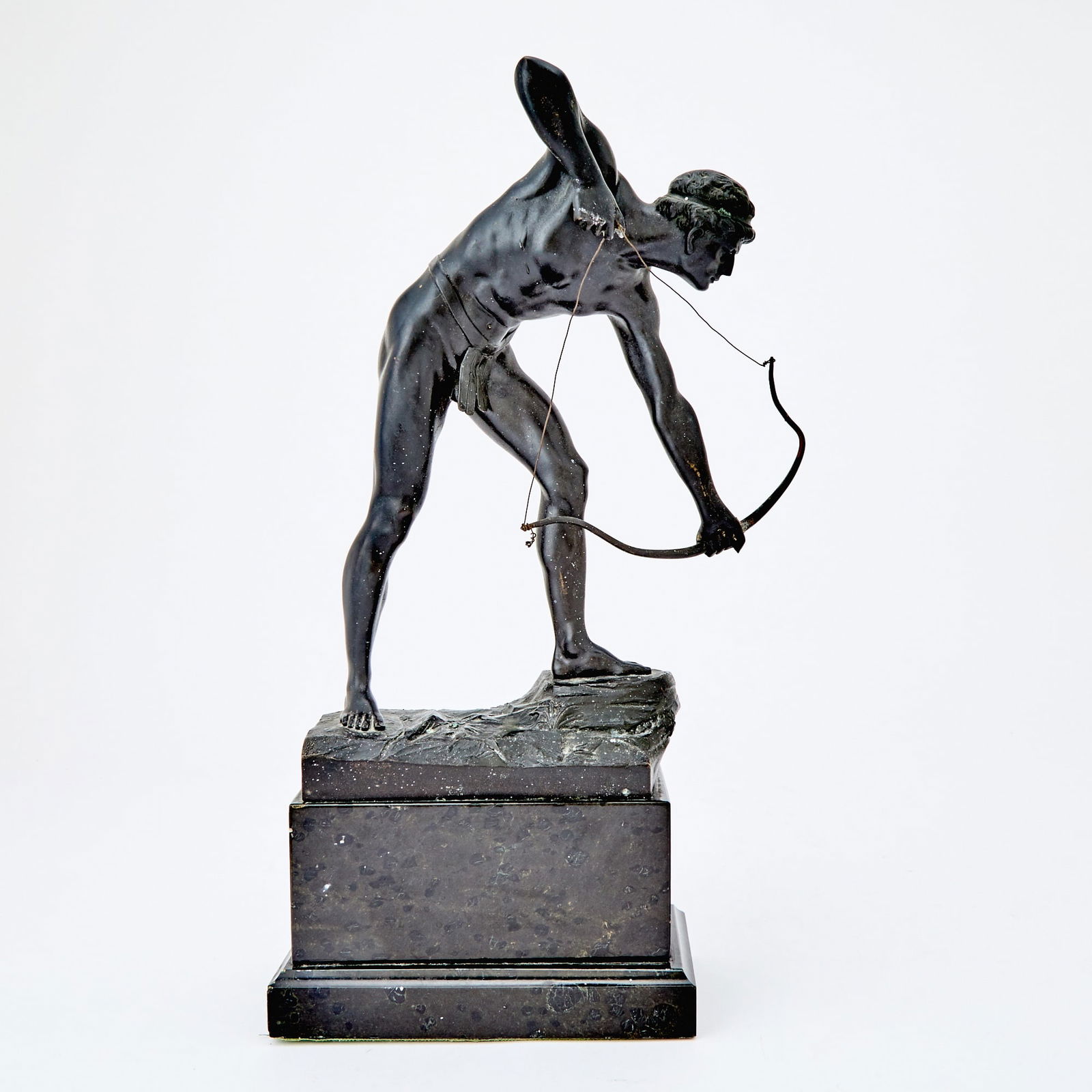 German Patinated Bronze Figure of a Male Archer: Cast from a model by Otto Schmidt-Hofer, first quarter 20th century Modeled in the nude in a forward leaning stance, standing atop a rocky mound with his bow arched, mounted on a polished black marble
