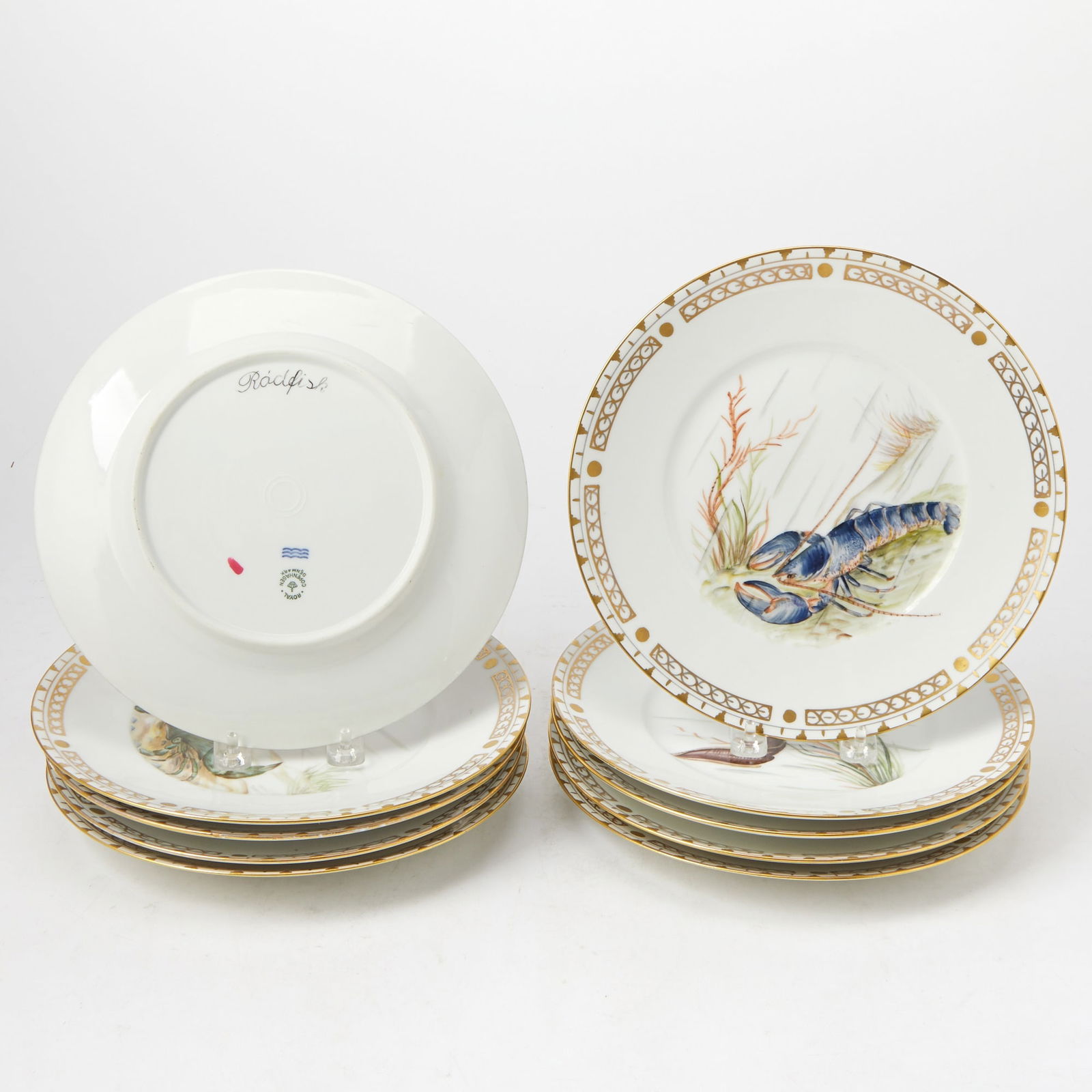 Set of Ten Royal Copenhagen Porcelain Dinner Plates Painted With Marine Life: Outside decorated. Diameter 10 inches. Four bearing canceled factory mark in red, outside painted, rub to gilt borders.