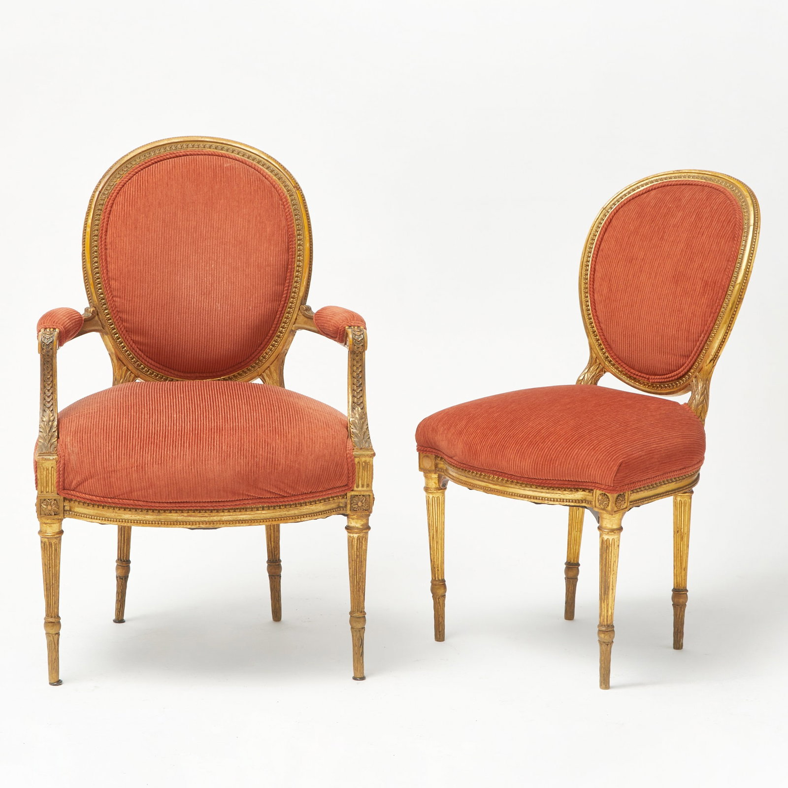 Set of Twelve Louis XVI Style Giltwood Dining Chairs: Including four armchairs and eight side chairs. Height of armchair 38 1/2 inches, width 25 inches, depth of seat 21 inches, height of seat 18 inches.