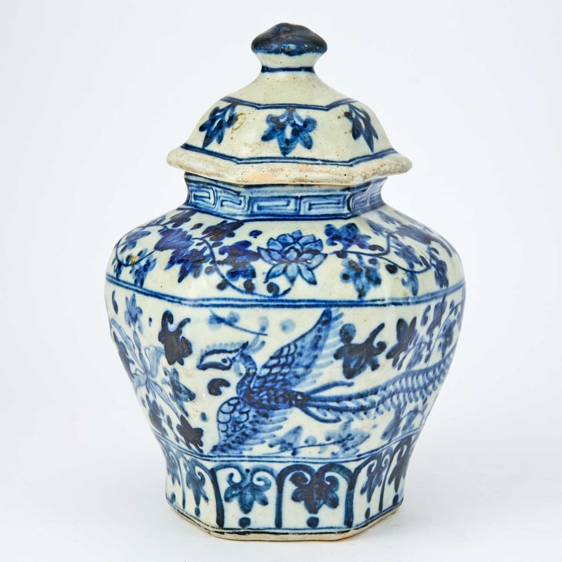 A Chinese Blue and White Hexagonal Jar and Cover Ming Dynasty: The high-shoulder jar decorated to show phoenix and lotus flowers on leafy vines. (Height 7 1/2 inches)