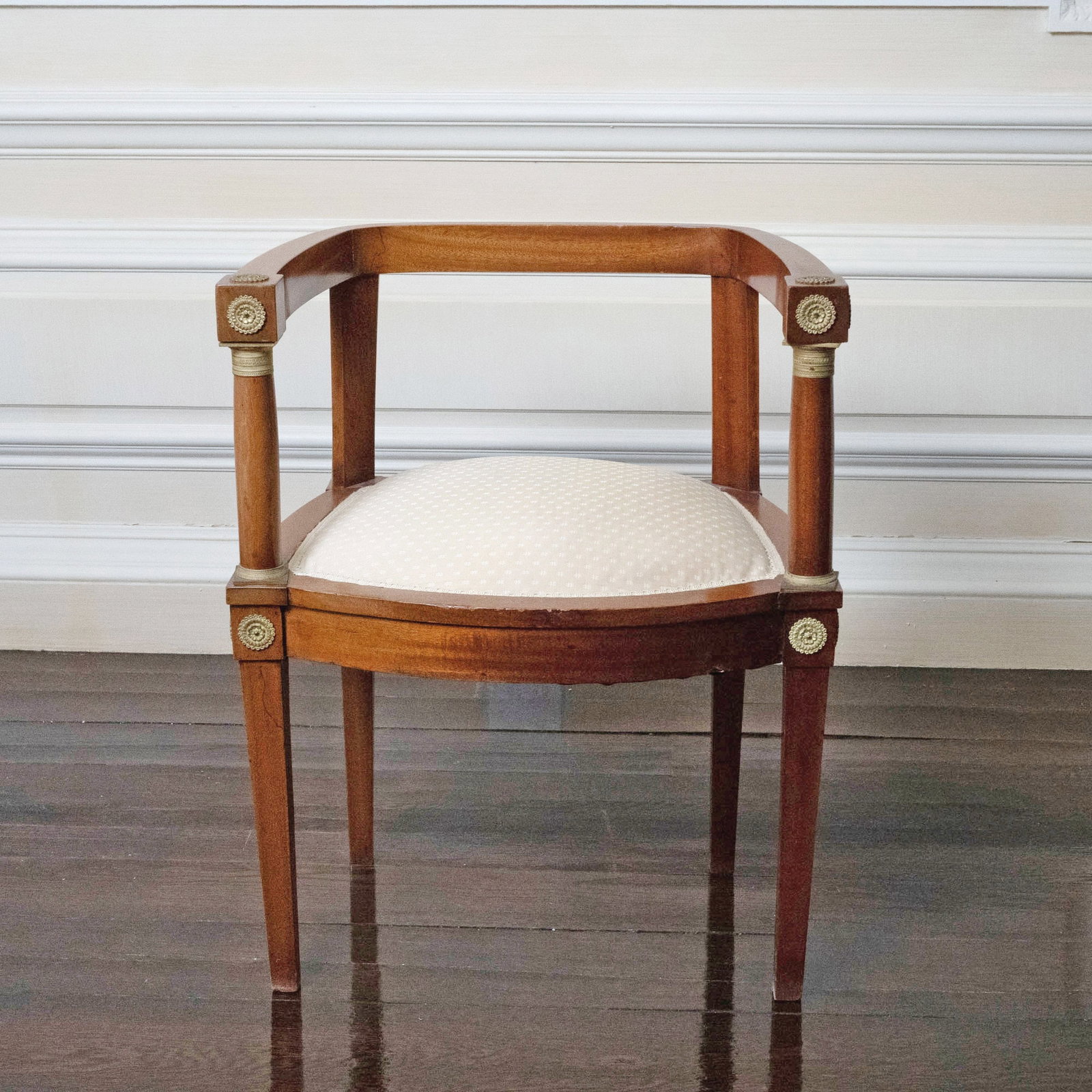 French Empire Style Bronze Mounted Mahogany Armchair: Circa 1920. Height 30 inches, width 23 inches, depth 20 1/2 inches. Seat height 19 inches. In fair condition with surface scratches. Missing one round bronze medallion mount.