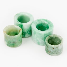 Four Chinese Jadeite Thumb Rings 19th-20th Century
