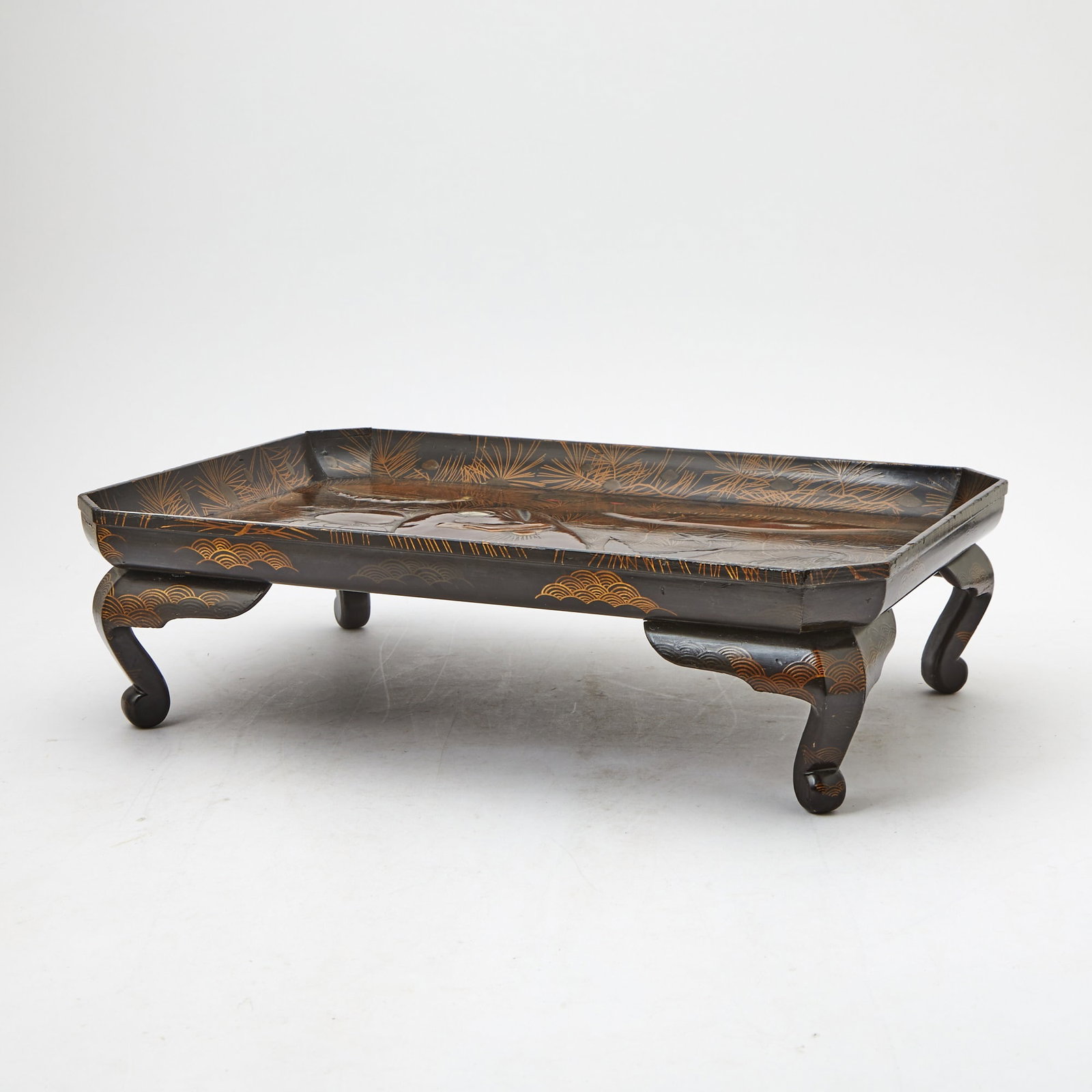 A Japanese Parcel Gilt Lacquer Footed Tray Edo Period: Of rectangular form with rounded walls and canted corners; with molded aquatic creatures including fish, spiny lobster, octopus and various mollusks, one with abalone inlay; raised on cabriole legs. (
