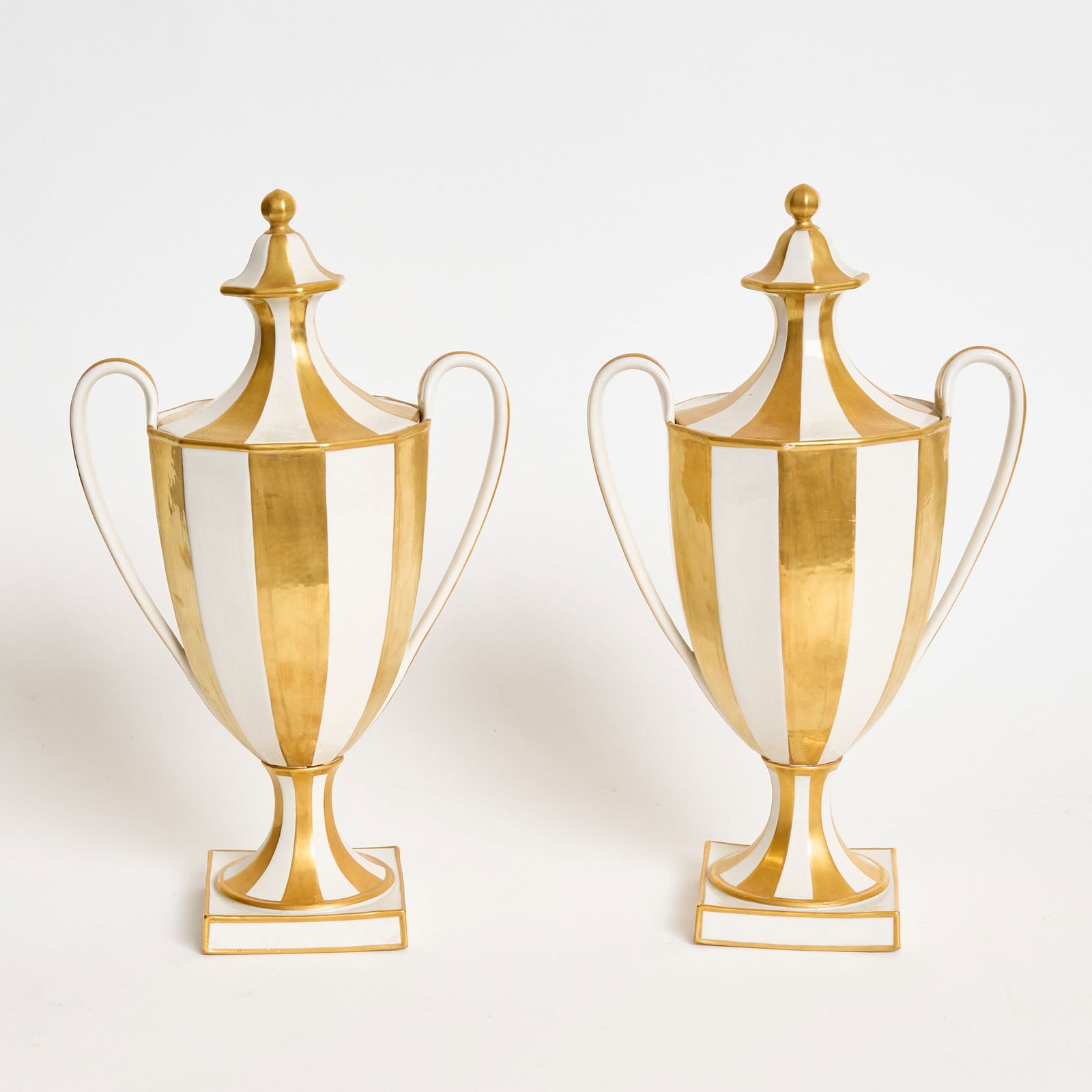 Pair of Italian Mottahedeh Gilt-Decorated Porcelain Covered Vases: Height 14 3/4 inches, width over handles 8 1/4 inches. losses to gilding; hairline to one handle