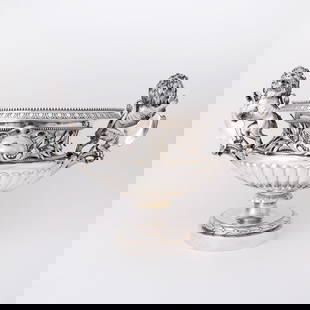 Victorian Sterling Silver Punch Bowl: Hunt & Roskell, London, 1877 Of campana-form with rampant lion handles and a frieze of applied branches, over a fluted section, on a pedestal foot. Height over handles 16 inches (41 cm), length ov