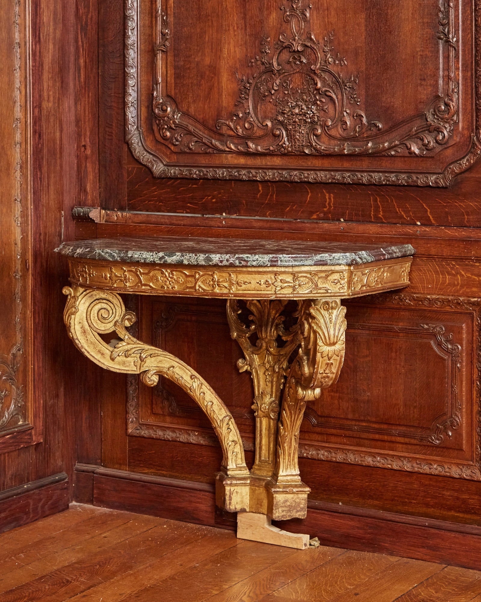 Régence Carved and Giltwood Console: First quarter 18th century The later bowed rosso levanto marble top above a molded frieze of strapwork and trailing husks on acanthus carved cabriole legs with flowering sprigs, shells and scrolled fo