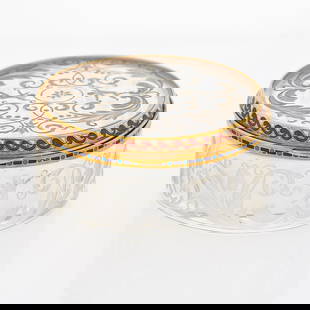 Continental Guilloche Enamel Gold Mounted Rock Crystal Pill Box: Late 19th century, unmarked, French or Austrian Of circular form, the clear-cut glass body decorated with scroll and floral motifs, bordered by a gilt enamel rim, Height 1 inch (2.5 cm), diameter 2 in