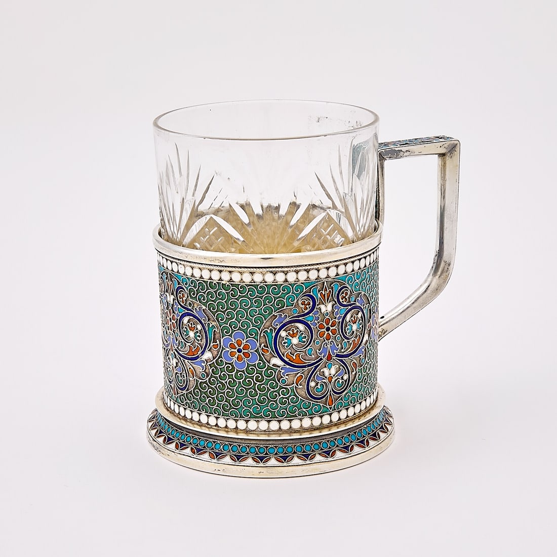 Russian Silver and Cloisonné Enamel Tea Glass Holder: Gustav Klingert, Moscow, 1895 Cylindrical, with a key-form handle, on a domed circular foot, reserved with varicolored flowers and foliage on a turquoise enamel ground with filigree scrolls, within wh