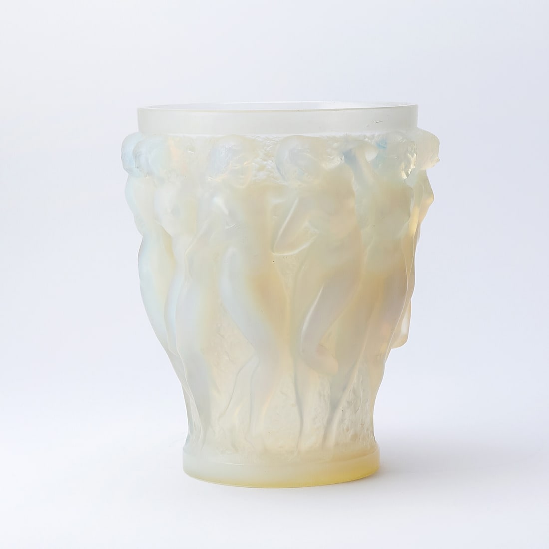 R. Lalique Molded Opalescent Glass 'Bacchantes' Vase: Marcilhac no. 997, circa 19 - Of tapering circular form, the body molded with a frieze of ten frolicking nude women, in high relief, engraved on the underside R. LALIQUE FRANCE No. 997. Height 9 1/2 i