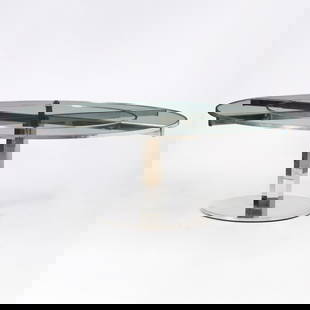 Nickel-Plated Steel and Glass Circular Extension Dining Table: Commissioned for the Waldorf Astoria Hotel, New York, circa 1931 The circular top with six semi-circular leaves. Height 29 inches, diameter without leaves 52 inches; diameter extended 6 feet 8 inches.
