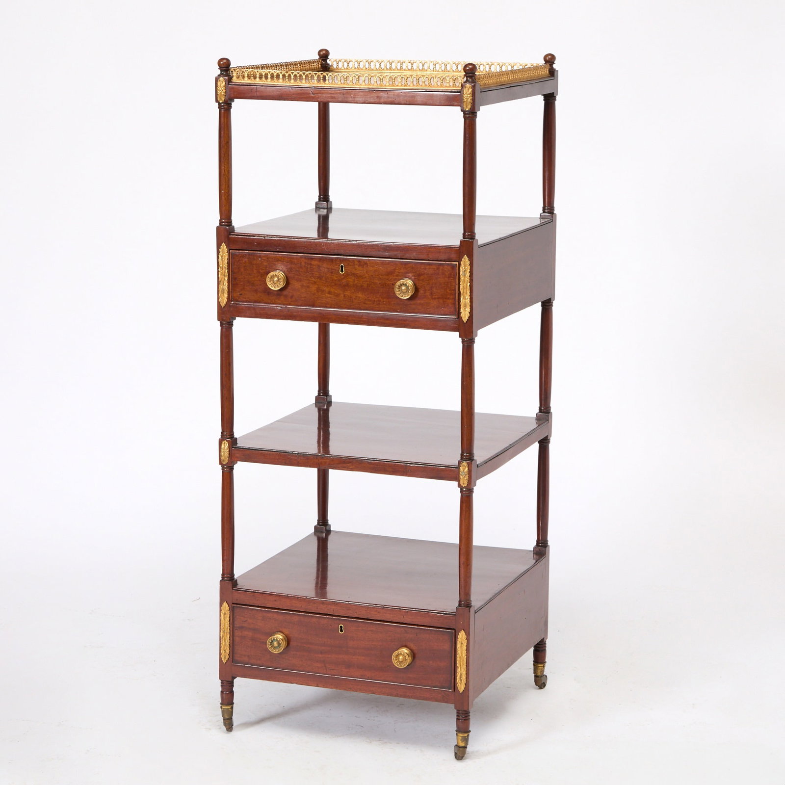 Regency Gilt-Metal Mounted Mahogany Etagere: Height 51 1/4 inches, width 19 3/4 inches, depth 19 3/4 inches. Warping, losses and rubbing to gilt mounts, gallery loose, drawer pulls in need of tightening, shrinkage throughout, third tier