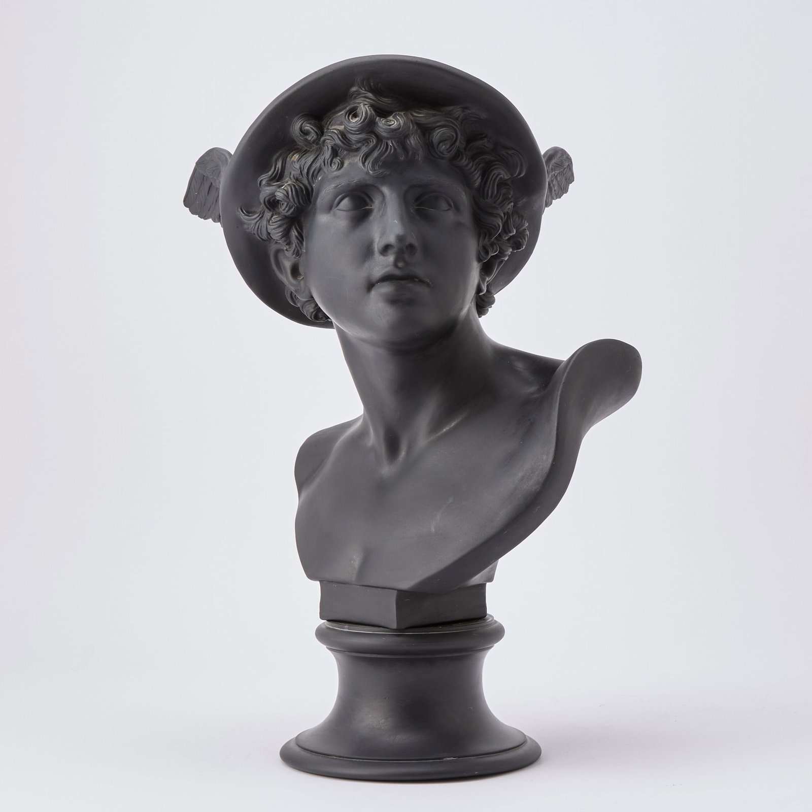 Wedgwood Black Basalt Bust of Mercury: Modeled in three-quarter side profile, on a socle, impressed MERCURY and WEDGWOOD. Height overall 18 1/4 inches, width 11 inches.