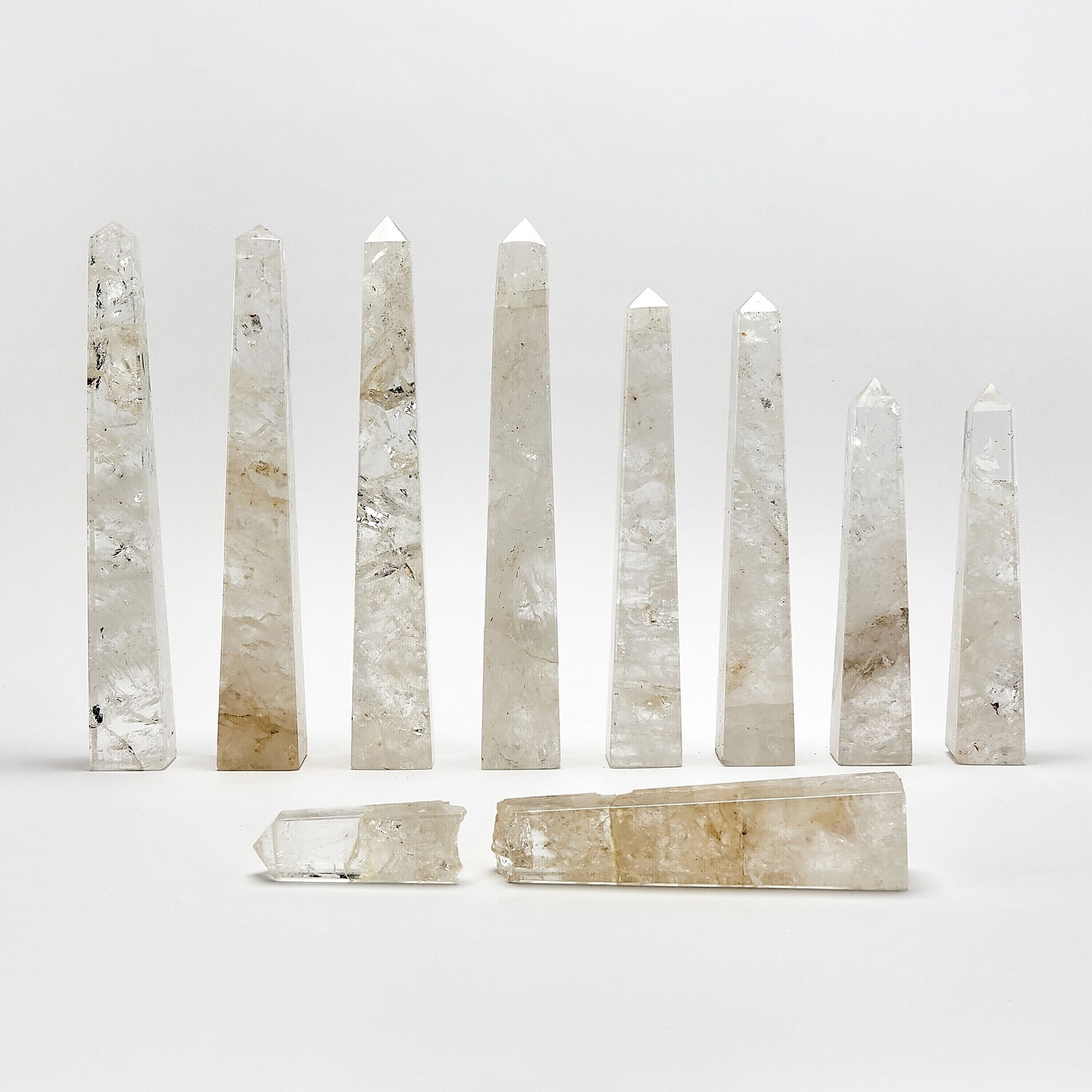 Group of Nine Rock Crystal Obelisks: Of various sizes. Tallest 14 inches. Some with repairs to tops and bottoms, one broken, with chips and loses to edges.