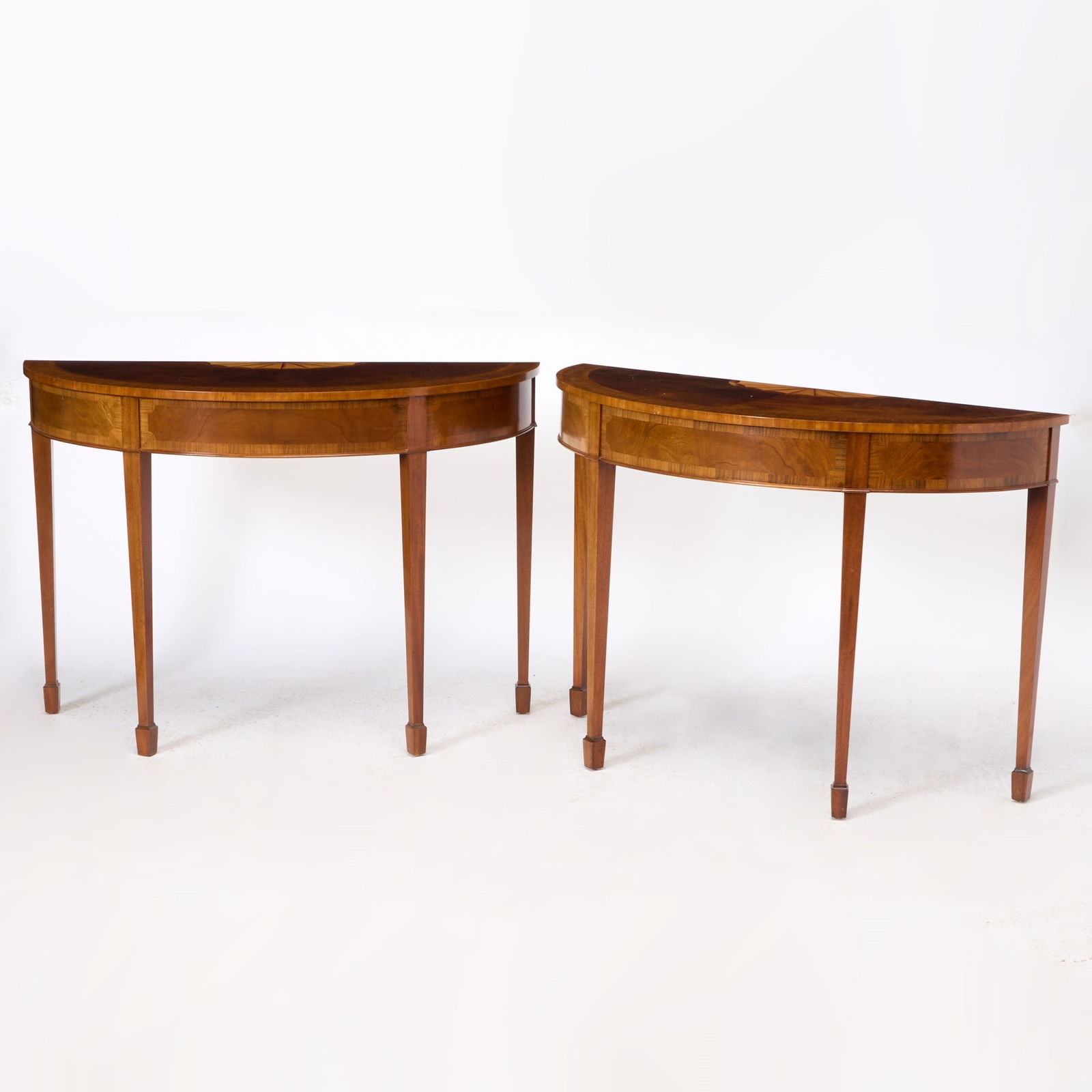 Pair of George III Style Inlaid Mahogany Demilune Console Tables: Estate / Collection: Property of an Upper East Side Collector 20th Century Height 32 1/4 inches, width 45 3/4 inches, depth 19 1/8 inches.