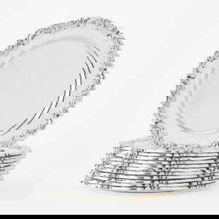 Set of Twelve Peruvian Sterling Silver Bread and Butter Plates: 20th Century Each with a rocaille decorated border and irregular rim, stamped F.P.C. within a lozenge device and 925 STERLING. Diameter 6 1/2 inches. Total approximately 73 ounces. (12)