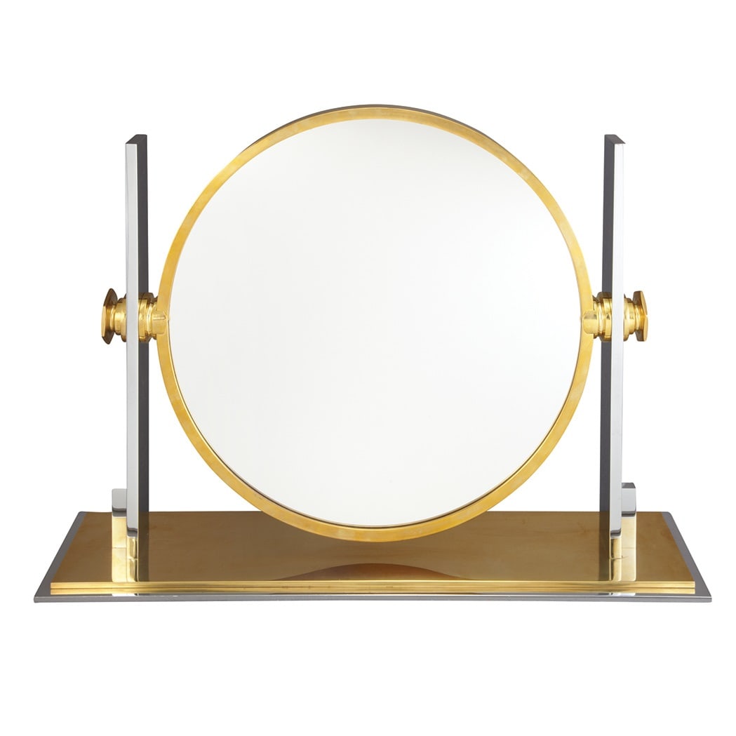 Karl Springer Brass and Chromed Metal Vanity Mirror: 1980s With circular swivel mirror within a pair of rectangular supports, on a conforming two-tone stepped base, unmarked. Height 19 inches, width 26 inches, depth 6 1/4 inches.