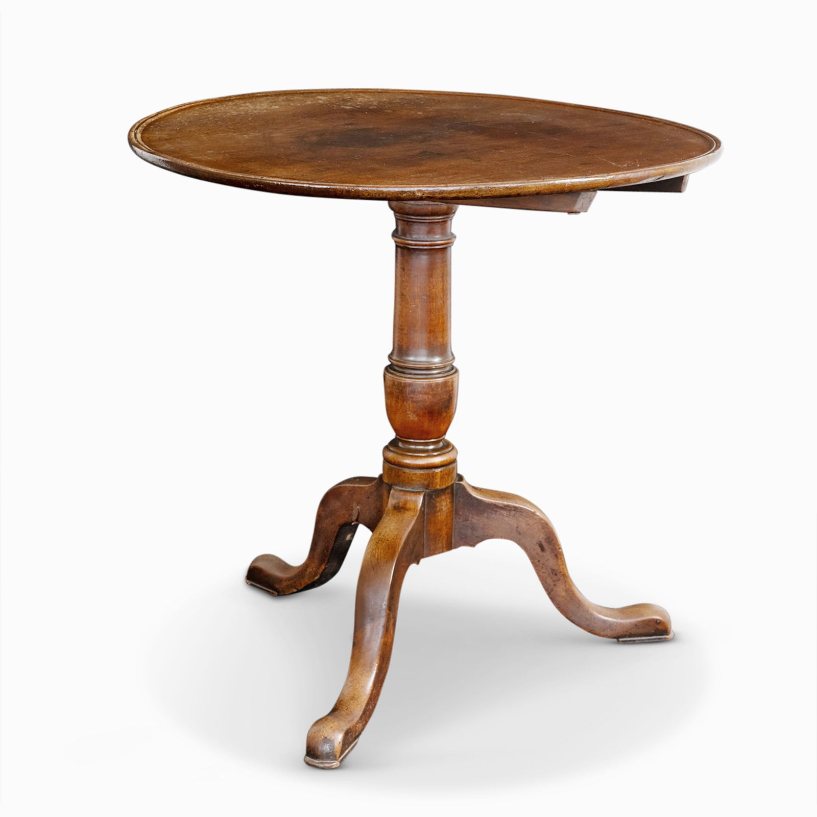George III Mahogany Tilt-Top Tea Table: Late 18th century With circular dished top and tripod base of cabriole legs. Height 29 inches, width 30 inches.