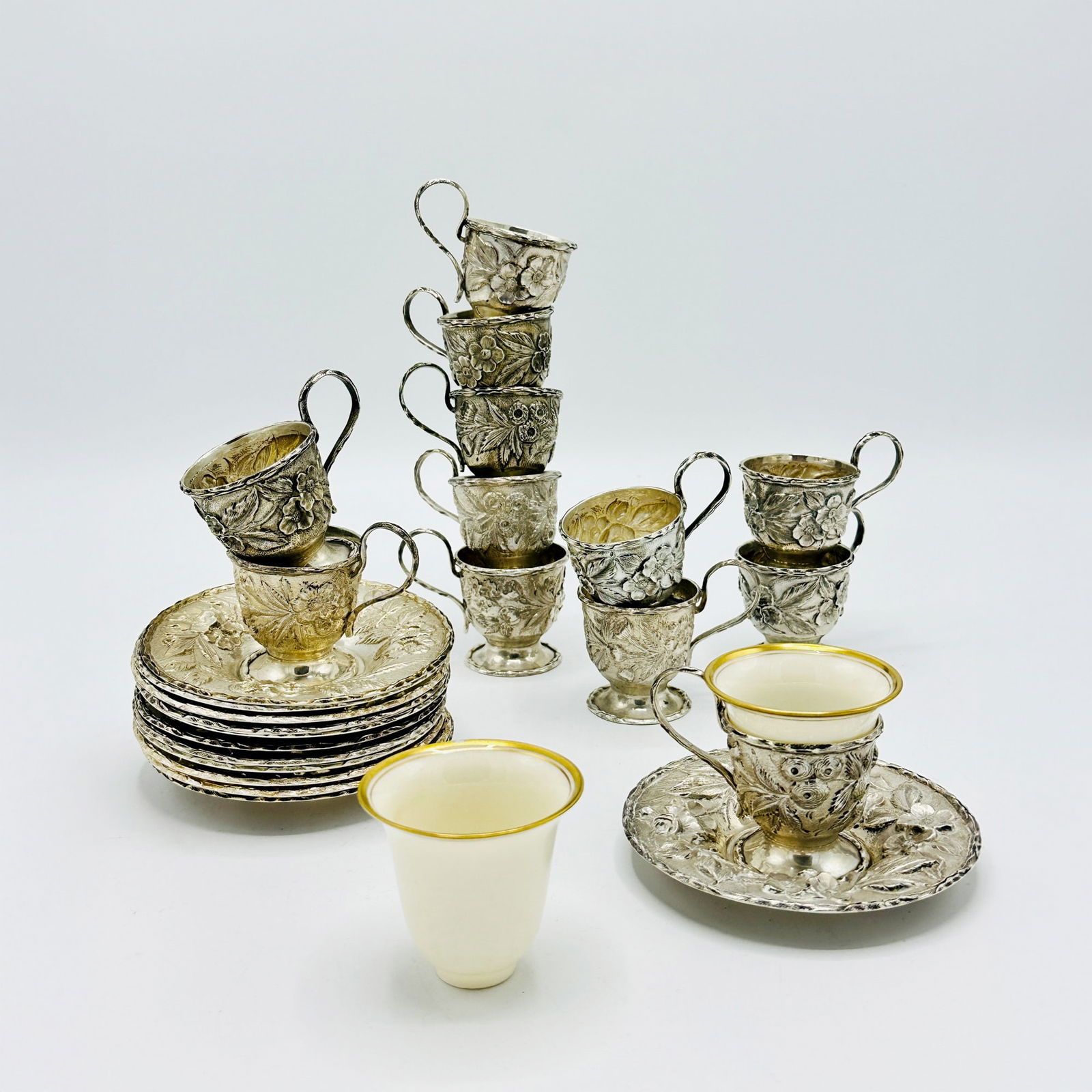 Set of Twelve S. Kirk & Son Repousse Sterling Silver Demitasse Cups and Saucers: With ten Lenox porcelain inserts. Approximately 30 ounces, weighable.