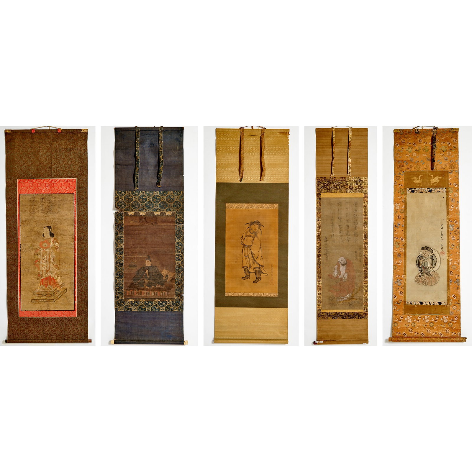 Five Japanese School Paintings Edo/Meiji Period: Comprising ink and color on silk paintings of a priest, a female Buddhist attendant, the standing figure of Shoki, Daruma, and Daikoku. (Sight height of largest 39 inches)